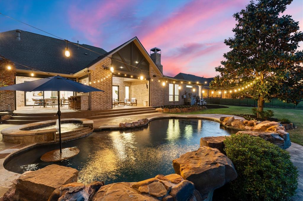 Welcome to a true unicorn in the heart of Prosper—where luxury, privacy, & design come together on just under an acre in the prestigious community of Whispering Meadows. Perfectly positioned on a premium corner lot with no neighbors behind, this Dave R Williams stunning home offers breathtaking, uninterrupted views of lush green space. Step inside and prepare to be captivated. The expansive single-story floor plan is thoughtfully designed with 4 spacious bedrooms, 4 full baths, a game room, & a media room, offering the perfect blend of everyday comfort and elevated entertaining. At the heart of the home, a completely reimagined designer kitchen steals the show—featuring all-new high-end appliances, Italian marble, stunning finishes, & a massive prep kitchen pantry you must see to believe. Every inch of this home has been meticulously updated with over $600K in top-to-bottom designer upgrades  - truly a turnkey masterpiece. The living & dining spaces are nothing short of spectacular, highlighted by dual sliding glass doors spanning the back of the home, creating a seamless indoor-outdoor experience & overlooking the private backyard oasis. The primary suite is a retreat of its own, offering an oversized layout with a private attached study, a spa-inspired bathroom, & luxurious finishes throughout. Additional standout features include a dedicated craft room with private exterior access to a dog run, a wine room with built-in desk & a stylish wet bar & more - every detail thoughtfully curated. Step outside to your own resort-style escape—complete with a sparkling pool and spa, oversized covered patio with fireplace, outdoor kitchen, bar & automated drop-down shades. You will also appreciate the rare 5-car garage & TEXAS BASEMENT space! All on an expansive lot with room to breathe- an incredibly rare find in Prosper. This is more than a home—it’s a fully transformed, designer showplace where no detail has been overlooked. Opportunities like this are few and far between.