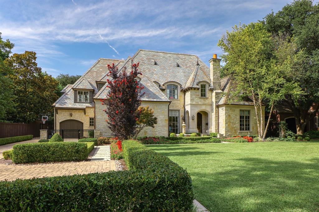 This custom home by Allen Nixon is a standout in Preston Hollow, showcasing the highest-quality designer finishes throughout. A timeless stone exterior, slate roof, and copper gutters set the architectural tone, while the two-story foyer opens to a formal dining room with lacquered walls, a sweeping staircase, and a richly paneled library.
The chef’s kitchen is equipped with premium appliances and opens to a stylish breakfast area with banquette seating and an inviting adjoining sitting room. The vaulted primary suite is conveniently located on the main level with serene views of the manicured backyard and pool.
Upstairs, you’ll find three additional en-suite bedrooms, a seven-seat theater, and a vaulted game room with an adjacent gym. Outdoor living is elevated with a resort-style pool and spa, screened-in porch with motorized screens, and a fully equipped summer kitchen. A three-car garage and elevator-ready design complete this exceptional offering—perfectly suited for multi-generational living.