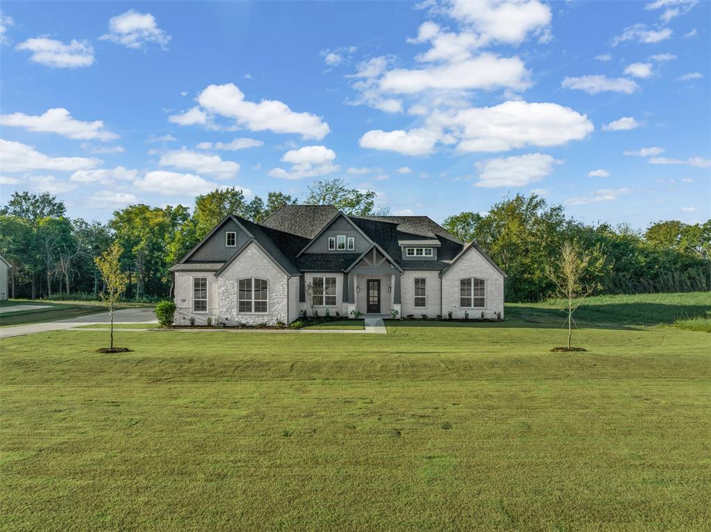 OPEN HOUSE SATURDAY JUNE 20TH 12-2PM AND SUNDAY JUNE 21ST 2-4PM. Built by John Houston Homes – Ready Now! This stunning new construction in the highly desirable Waterfall Ranch community offers over 3,090 sq. ft. of thoughtfully designed living space on a beautiful one-acre, tree-lined lot. Featuring four spacious bedrooms, three full baths, and two inviting living areas, this home perfectly balances luxury and comfort. The open-concept design showcases soaring vaulted ceilings, a floor-to-ceiling gas fireplace with custom built-ins and gas logs, and beautiful luxury vinyl plank flooring throughout the main living areas. The chef-inspired kitchen features granite countertops, a large island, double ovens, a gas cooktop, an oversized walk-in pantry, and large windows overlooking the scenic backyard—filling the space with natural light and charm.The primary suite is a peaceful retreat with a spacious layout and a luxurious bath offering dual vanities, a freestanding tub, and a walk-around shower. Step outside to a large covered patio that overlooks a fully treed, park-like backyard—perfect for outdoor relaxation and gatherings.Additional highlights include a three-car garage, decorative lighting, high-speed internet availability, and modern heating and cooling systems. Don’t miss your chance to own this exceptional home by John Houston Homes in Waterfall Ranch—where craftsmanship meets elegance!