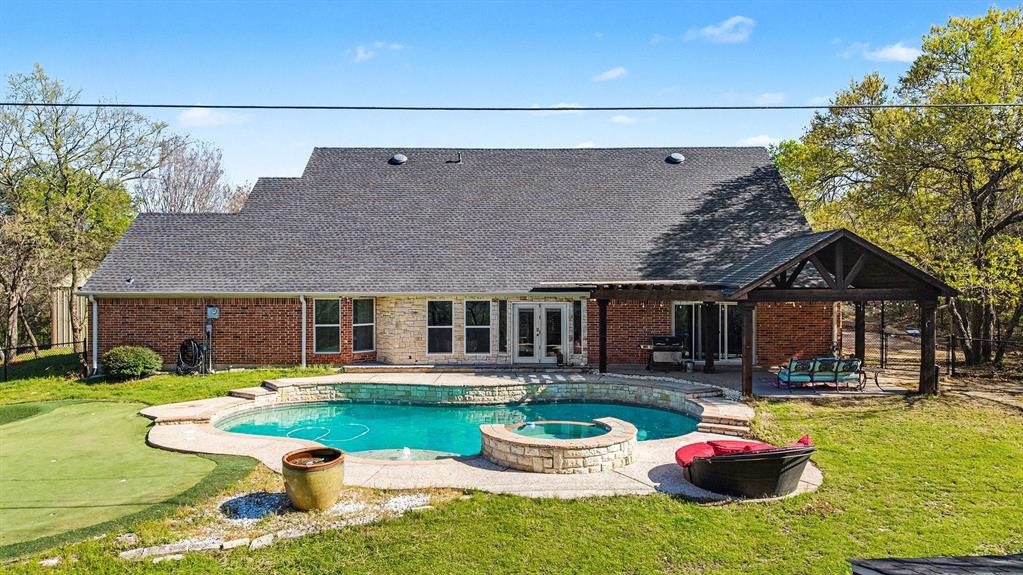 Highly motivated sellers as they are relocating out of state!! Tucked away on 2 private acres in desirable Waxahachie, this stunning 4-bedroom, 3-bath home offers the perfect blend of space, comfort, and privacy. Situated on a beautifully positioned piece of land, this property provides peaceful country living while still being just minutes from everything Waxahachie has to offer.
Step inside to an amazing chef’s kitchen designed for both entertaining and everyday living, featuring an oversized island, commercial-grade refrigerator, bar seating, and a built-in desk area, creating the perfect gathering space for family and friends. The home also features an oversized dining room, ideal for hosting holidays and special occasions, along with a butler’s pantry that provides additional prep and storage space.
A dedicated office at the front of the home makes working from home easy, while the flexible layout also includes a game room and a bright sunroom overlooking the backyard.
The oversized primary suite is a true retreat with a completely updated spa-like bathroom featuring a soaking tub, walk-in shower, and dual vanities. Two secondary bedrooms share a charming Jack-and-Jill bathroom, offering both style and functionality.
Step outside and enjoy your private backyard oasis complete with a gorgeous in-ground pool, covered back porch, sunroom, and your very own putting green—perfect for relaxing or entertaining. A metal storage building has also been added,  the metal shop building is 1200 sqft providing additional storage and functional space for hobbies, equipment, or outdoor gear.
This home is full of valuable upgrades, including pool equipment, updated windows, roof, and HVAC, giving buyers peace of mind and added value.
With incredible indoor living areas, resort-style outdoor amenities, and unmatched privacy on 2 acres, this Waxahachie property truly has it all.