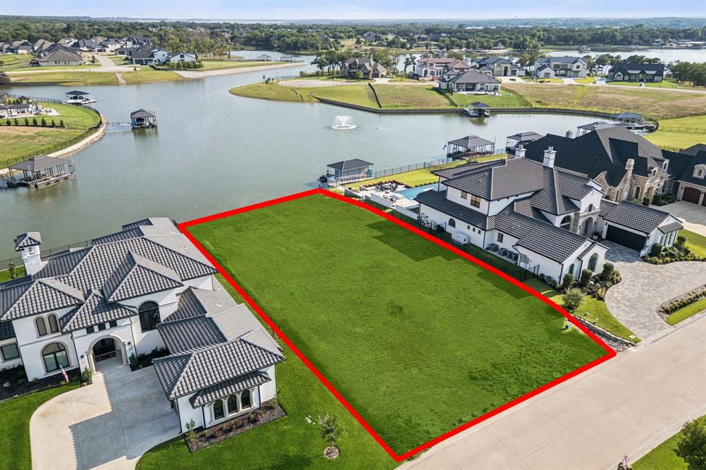 Discover the perfect canvas for your dream home on this rare .46-acre waterfront lot in one of Eagle Mountain Lake’s most prestigious gated communities. With sweeping views of the open water, direct access from the canal, and surrounded by custom luxury estates, this homesite offers an unmatched blend of elegance, privacy, and recreation. This expansive lot provides plenty of space for a custom build with room for a pool, outdoor living, and a private dock, allowing you to enjoy lake life to the fullest with boating, fishing, and water sports right from your backyard. The level topography makes it ideal for bringing your vision to life, whether you dream of a modern masterpiece or a timeless lakeside retreat.You’ll enjoy easy access to nearby dining, shopping, and entertainment while still experiencing the tranquility of a private lakeside escape. Opportunities like this are rare—come see for yourself and start planning your dream home on Eagle Mountain Lake. Enjoy resort-style living in the 24-7 gated & guarded Resort on Eagle Mountain Lake with access to premier community amenities, including a 19-hole golf course, clubhouse with restaurant & bar, two pools, a fitness center, pickleball & basketball courts, private beach area, boat dock, boat ramp, and more.