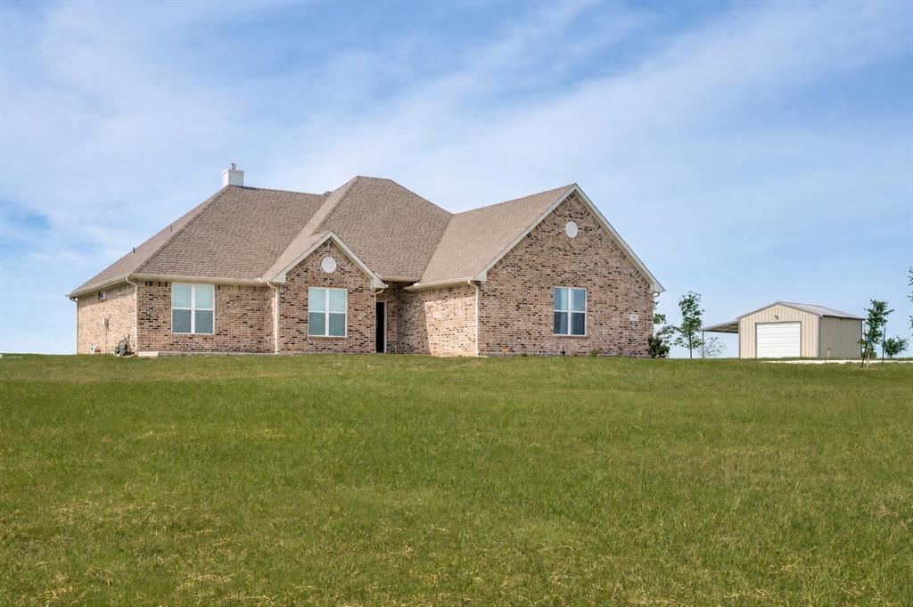 Welcome to 360 Private Rd 4000 in Gainesville, Texas. Tucked away in the Eagle’s Perch Subdivision, where privacy, elevation, and breathtaking views come together to create the ultimate North Texas retreat.

Situated on a stunning 5 acre hilltop tract, this custom-built brick home (2022) offers panoramic countryside views and a peaceful setting surrounded by nature. Deer, turkey, and native wildlife are frequent visitors, adding to the charm.

Designed with both luxury and functionality in mind, this 4-bedroom home features an open-concept layout filled with natural light. Expansive windows adorned with plantation shutters frame scenic views from nearly every room. The inviting living area boasts a cathedral ceiling, gas log fireplace, and full glass doors that seamlessly connect indoor comfort with outdoor beauty. 

The heart of the home is a spacious eat-in kitchen built for gathering, complete with knotty alder custom cabinetry, quartz countertops, a gas oven, and an oversized pantry. Every detail reflects quality craftsmanship and thoughtful design.

The private primary suite is a true retreat, offering a spa-like bathroom with a custom tile shower, oversized walk-in closet, and serene finishes that create your own personal oasis.

Step outside and enjoy the versatility of an 18x20 workshop with concrete floors and electricity, plus a 10x20 overhang, ideal for storing a boat, recreational vehicles, or tackling your next project.

Additional highlights include a fully installed Generac whole-home generator with warranty, providing peace of mind year-round.

Enjoy lake life just minutes away—Moss Lake and the boat ramp are only 3 miles from your doorstep. Despite its secluded feel, the property offers convenient access to Highway 82 and I-35, and is just 15 miles from downtown Gainesville.

If you’ve been searching for acreage in North Texas with modern construction, scenic views, and unmatched privacy, this property is a must-see.