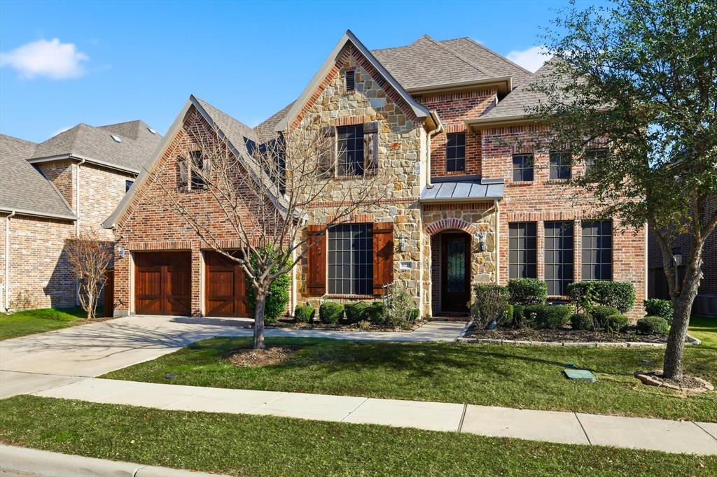 Seller Considering All Offers! TRANQUIL WATER VIEWS immediately draw you in at this beautiful, light-filled home in the golf resort–style community of The Tribute, overlooking one of the neighborhood’s scenic lochs with no direct rear neighbors. This thoughtfully designed home offers 4 bedrooms and 4 baths, including two full ensuites, plus a dedicated office featuring custom floor-to-ceiling built-ins and hardwood floors. Sun-drenched living spaces highlight an open-concept kitchen that flows seamlessly into the main living area, accented by expansive windows, two inviting fireplaces, an oversized center island, and abundant storage. The kitchen is equipped with ceiling-height cabinetry, double ovens, a gas cooktop, stainless steel appliances, and breakfast bar seating. A charming dining area includes a fireplace and built-in buffet for added elegance. The primary suite features a jetted tub and separate vanities, creating a private retreat. Upstairs, a spacious family area, additional bedroom, and private ensuite provide an ideal setup for generational living or guests. Step outside to a large backyard with a pergola-covered patio, perfectly positioned to enjoy peaceful water views. Residents of The Tribute enjoy miles of hike and bike trails, two championship golf courses, resort-style pools, splash pad, private pickleball courts, lakefront trails, a nature preserve, and year-round HOA events, all just minutes from Grandscape and major highways.