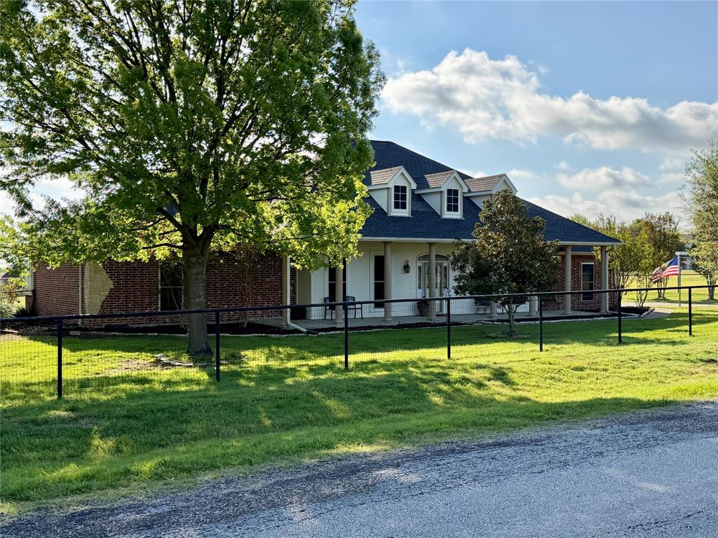 PRICE REDUCED – BACK ON THE MARKET! Don't Miss Your Second Chance!  Enjoy peaceful country living with NO CITY TAXES on this beautifully custom-built 3-bedroom, 2.5-bath home situated on a fully fenced 1-acre lot in the highly sought-after Red Oak ISD.  From the moment you arrive through the electric gated entrance, you'll appreciate the privacy, mature trees, and exceptional curb appeal. Inside, the spacious open-concept floor plan is designed for comfortable everyday living and entertaining. The kitchen features beautiful custom wood cabinetry, abundant storage, a pantry, and an additional oversized storage closet that makes an ideal overflow pantry. The kitchen flows seamlessly into the breakfast area and inviting living room.  The generously sized bedrooms provide plenty of space, while the laundry room continues the home's quality craftsmanship with additional custom wood cabinetry.  Step outside and enjoy everything this property has to offer! The fully fenced yard with durable pipe fencing provides plenty of room for kids and pets to play. Extensive concrete areas are perfect for riding bikes, skating, or outdoor activities. The backyard offers endless possibilities and is simply begging for your dream pool! A full sprinkler system services the front, side, and backyard all the way to the garden area.  Additional features include:  Paid-in-full solar panels that stay with the home, oversized garage with a built-in tornado shelter, 18' x 48' workshop with electricity, concrete flooring, a large storage room, and loft space.  Separate backyard building currently used as a garden shed, with endless potential as a charming She Shed, hobby room, or studio.  This one-of-a-kind property offers the perfect blend of comfort, functionality, and space—inside and out. Come experience everything this exceptional home has to offer. Schedule your private showing today!