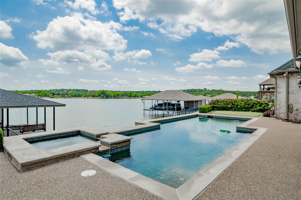 Rare opportunity to own stunning Main Body Waterfront home in Harbor Lakes.  Superior quality & craftsmanship throughout this custom home. True 4 bedroom home with additional office & formal dining.  Open floorplan living, dining and kitchen all look out over the pool to Mainbody Lake Granbury. Lower level offers oversized master & spa bath complete with walk-in closet as well as additional bedroom & full bath. Upper floor offers guest 2 ensuite bedrooms both with access to the large balcony offering stellar views of the lake. From the lower living area step out onto the covered patio with fireplace & built-in grill. Enjoy the heated pool with built in spa while watching the boats skim the water of the lake.  Join them on the lake from this walk out water location with private covered dock with boat & jet ski lifts.Overside garage and 3rd separate garage is perfect storing and parking all the toys.