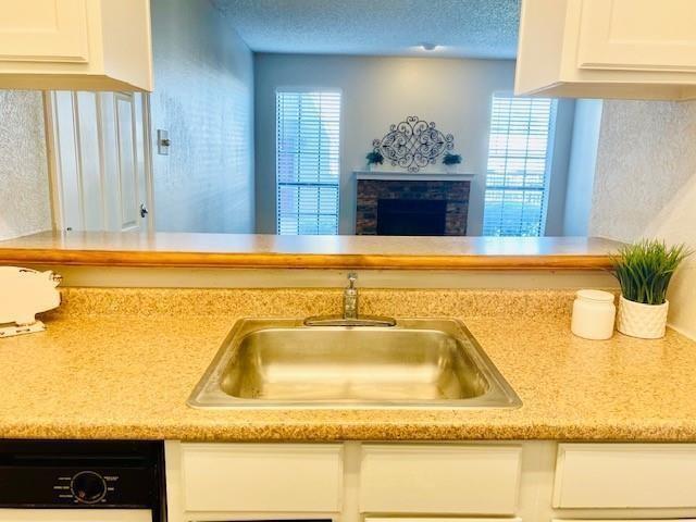 An exceptional opportunity for affordable North Dallas homeownership without sacrificing location or updates. This rare first-floor opportunity in Plano ISD with direct pool access is a must see! This fully updated, move-in-ready North Dallas condo offers seamless luxury vinyl plank flooring and a crisp neutral palette throughout. The open-concept living area features a warm brick wood-burning fireplace and natural light. The kitchen comes fully equipped with an included refrigerator and microwave. Relax in the oversized primary suite with a huge walk-in closet and direct access to a private covered patio with exterior storage. Unit #108 is the ONLY residence in the complex with a private gate leading directly to the community pool area! Includes assigned parking space #108. Minutes from Central Market, UTD, tech corridors, dining, and major freeways.