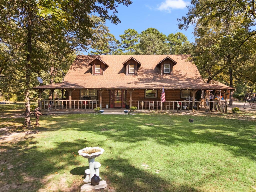 Don’t miss the opportunity to own this beautiful custom-built home tucked away on over 37 sprawling acres of peaceful countryside along with two large ponds - one that creates a stunning view from the cabin's back patio! This exceptional offering features two charming log cabin-style homes, making it ideal for multigenerational living, guest accommodations, or income-producing potential. The main residence is a spacious 3 bedroom, 2.5 bath retreat with 2,700 square feet of inviting cabin living. Inside, you’ll be welcomed by warm wood finishes, a striking stone fireplace, and an abundance of natural light streaming through oversized windows. A wrap-around porch invites you to enjoy quiet mornings and breathtaking sunset views. The home also boasts a large kitchen with generous cabinet space, a center island, and ample storage throughout. Each bedroom is comfortably sized, while the primary suite offers a spa-like experience with a walk-in shower, garden tub, double vanity, and a dedicated makeup area. The second home is an approximately 660 sq. ft. studio-style cabin that has been successfully used as both a long and short-term rental. With its own covered front porch and cozy interior, it provides an excellent opportunity for rental income or a private guest retreat. Additional features include pipe fencing and a pole barn that offers convenient storage or shelter for equipment and animals, while a separate detached garage near the main home serves as a versatile workshop and carport combination, perfect for projects, hobbies, or additional covered parking. This stunning country escape offers privacy, charm, and endless possibilities. Schedule your showing today!