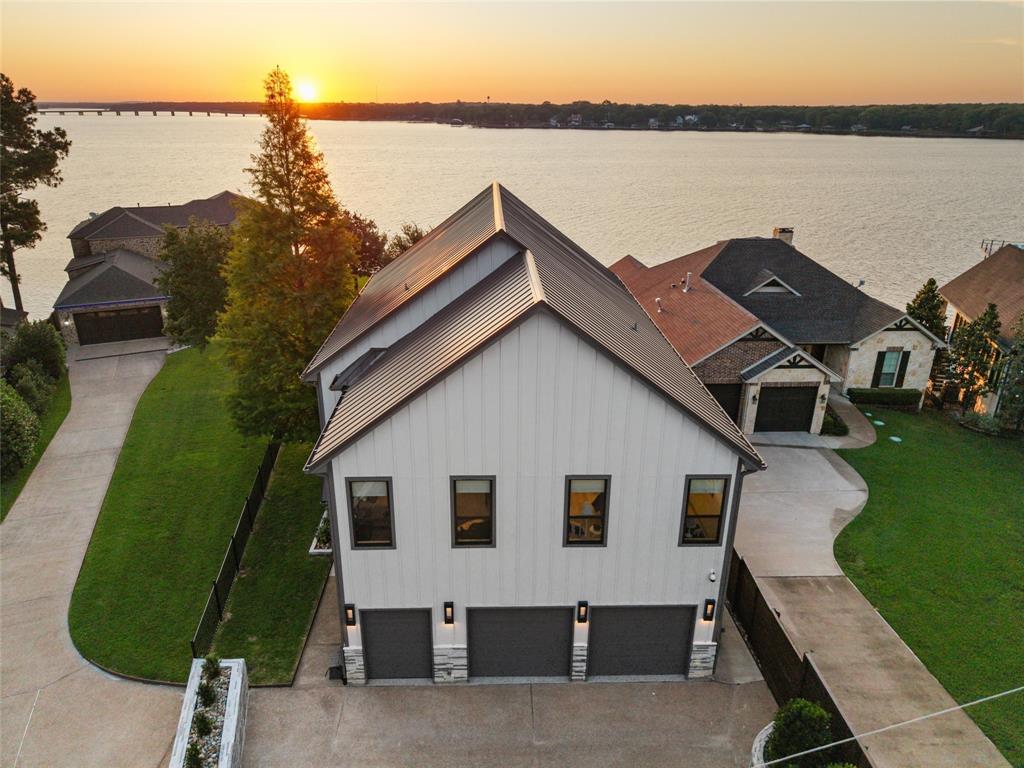 Welcome to this stunning gated 3-bedroom, 3-bathroom lake home built in 2023, perfectly positioned on the shores of Cedar Creek Reservoir. This turn-key residence offers an unparalleled blend of modern luxury and lakeside serenity, ready for immediate move-in. Step inside this meticulously designed home and discover an open-concept layout flooded with natural light. The gourmet kitchen is a chef’s dream, featuring high-end appliances, a built-in refrigerator, and a dedicated wine fridge—ideal for entertaining family and friends. Spacious bedrooms and beautifully appointed bathrooms provide comfort and privacy for everyone. Outside, the true magic unfolds. Enjoy breathtaking lakefront views from multiple vantage points. The expansive backyard is an entertainer’s paradise with a large pool and hot tub, an outdoor theater for movie nights under the stars, a cozy fire pit for gathering around, and a private boat dock for effortless access to the water. A 3-car garage provides ample space for vehicles and lake toys. This exceptional property offers the ultimate Texas lake lifestyle—whether you're fishing at sunrise, boating on the reservoir, or hosting unforgettable evenings by the pool. Located in a gated community, it combines privacy and security with convenient access to Mabank and all the amenities of the Cedar Creek Lake area. Don’t miss this rare opportunity to own a nearly new, move-in ready lakefront home. Schedule your private showing today and make 158 Surls Drive your forever lakeside retreat.