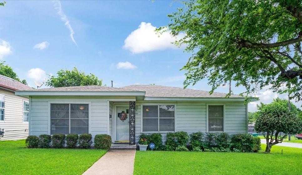 WELCOME HOME to your well cared for 3 bedroom, two bath home on a CORNER LOT!  You walk into a large living, dining room that is OPEN to the SPACIOUS kitchen!  There is a full washer, dryer closet conveniently located in the kitchen by the primary suite.  A good-sized peninsula allows for extra seating in the dining room.  The primary bedroom and bath are off of the kitchen, away from the other two bedrooms for extra privacy.  Bedrooms 2 and 3 are off of the living room (through a pocket door for saved space) and share a full bath.  There are original hardwoods under the carpet in these two bedrooms!  From the kitchen you will find your covered deck that has a ramp for easy access.  A great place to START OR END your day with your morning coffee or evening beverage!  The home has a LARGE 2 car garage with a small workshop in it.  There is also another, larger workshop with electricity in the backyard! The front part of the backyard is fenced off from the rest of the back making it a safe place for children or pets.  There is a double gate in the very back for easy access to the yard. The roof was replaced last year.  You will be close to your elementary and middle schools with a pretty straight shoot to the high school.  You will be close to a beautiful park, shopping, dining and churches as well as close access to Hwy 75 and Hwy 82.