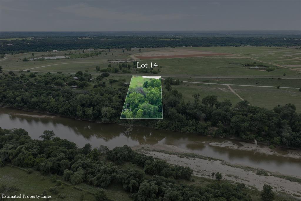 One of the most unique parcels in the area, Lot 14 offers direct frontage along a scenic river, giving you that rare combination of open pastureland and lush, wooded riverbank all in one property. From the paved road, the lot opens up into a wide, grassy clearing before transitioning into a beautiful canopy of mature hardwoods that line the river's edge — a natural paradise for fishermen, or anyone who simply loves the outdoors.
Aerial views reveal the incredible setting: sweeping green pastures, multiple ponds nearby, and miles of unspoiled Texas countryside stretching in every direction. The property benefits from paved road frontage and an internal drive, making access easy while still feeling completely removed from city life.
Whether you're envisioning a private riverside retreat, a hunting camp, or a custom home site with a view money can't buy, Lot 14 delivers. Abundant wildlife, and the peaceful sounds of the river — this is Texas land ownership at its finest, just a short drive from Fort Worth.