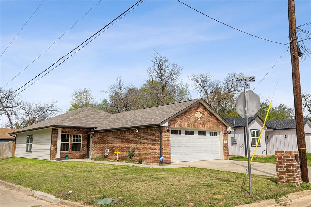 This newly constructed 4-bedroom, 2-bath home sits on a corner lot near downtown Sulphur Springs. Relax on the back patio or in the backyard hot tub, enclosed by a privacy fence. The yard is sodded with lush NorthBridge Bermuda grass, and a newly installed sprinkler system manages the whole property. Inside, enjoy luxury vinyl plank flooring and airy 9-foot ceilings in the living and dining areas. The kitchen and baths boast quartz countertops and a pantry. The private primary suite overlooks the backyard, featuring a tiled shower and dual walk-in closets. Three additional bedrooms offer versatility—ideal for a home office or gym. A welcoming front porch and full-size 2-car garage complete this inviting home.