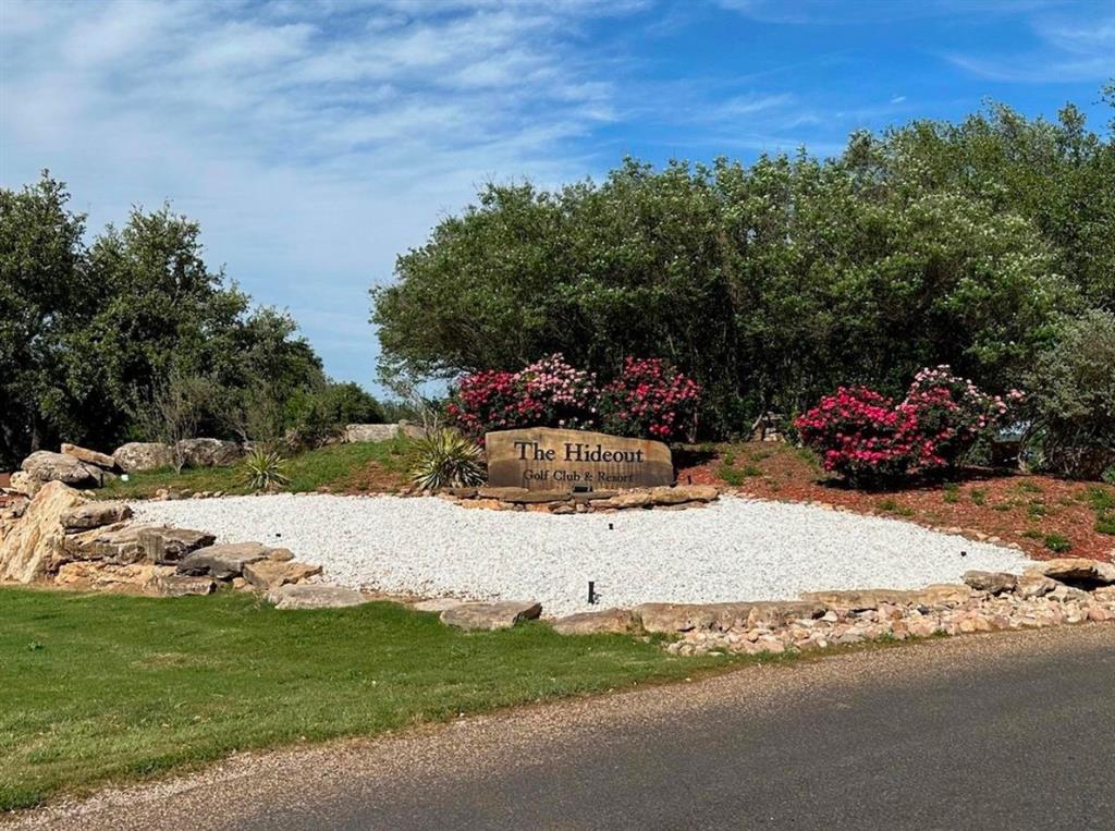 Home Lot at the Hideout Golf Course at Lake Brownwood. Water and Electric are available for this location. This Lot is a block over from 4 green. Ownership of this property includes 4 rounds of golf each month and reduce rates for RV Park and cabins. Also will have access to the swimming pool, hot tubs, volleyball courts and restaurant.