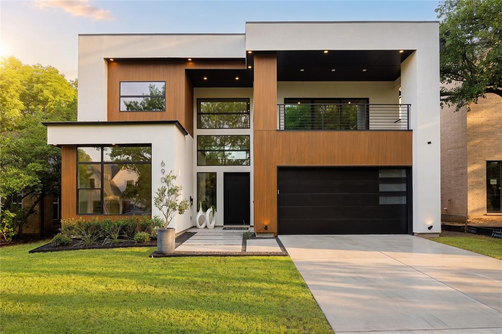 Tucked beneath the canopy of mature trees in the coveted Lakewood Area of East Dallas, This architectural gem New Construction brings a refined California inspired modern aesthetic.  Minutes from White Rock lake, Lakewood cafes, boutiques, and restaurants, this home blends organic textures with warm modern design. The residence was designed with clean lines, oversized windows, vaulted ceilings, and curated natural finishes throughout. The center of the home, The chef’s kitchen, is a standout with custom cabinetry, an oversized quartz Island, WOLF® dual-fuel range, 48-inch built-in refrigerator, wine cooler, dry bar with floating shelves, and an oversized walk-in pantry with convenient garage pass-through access.
The luxurious first-floor primary suite feels like a private retreat with vaulted ceilings, sliding glass doors to the backyard, spa-inspired bath with vessel soaking tub, oversized rainfall shower, dual vanities, and a custom walk-in closet. A separate guest suite or dedicated office with ensuite bath is also located downstairs. Separate office sits downstairs while upstairs offers dramatic game lounge with a wet bar opening to a private veranda. 
Upstairs features a large game room with wet bar opening to a covered veranda, plus three spacious secondary bedrooms, each with private ensuite baths and walk-in closets. Sophisticated yet relaxed, organic yet modern, Clayton is inspired lifestyle in the Heart of East Dallas.