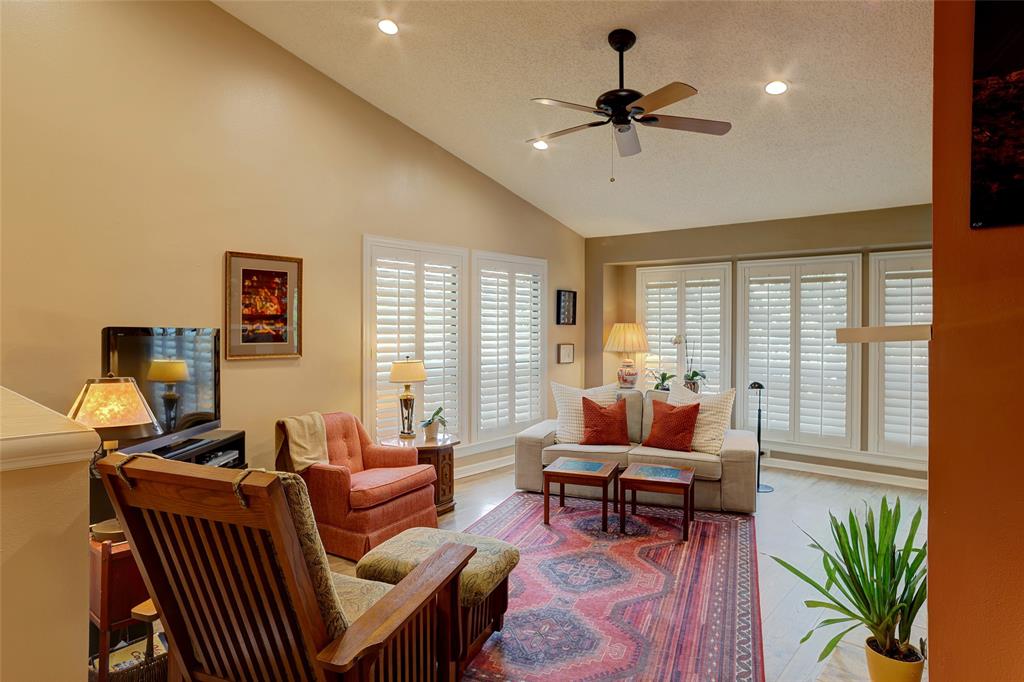 Nestled among a canopy of mature trees, this end-unit condo on the second floor offers a sense of privacy and serenity that is hard to find. With lush greenery and a peaceful setting surrounding the unit, you'll feel removed from the fast city pace — yet right in the heart of one of North Dallas' most sought-after locations. The community includes and features a beautiful waterfall pool and tennis court and is ideal for the lock-and-leave lifestyle. Worth mentioning that the HOA has strong reserves, is very responsive and meticulously maintains community grounds. Step inside this unit to find vaulted ceilings in the dining and living rooms, floor-to-ceiling windows, and an abundance of natural light throughout the unit. Plantation shutters add a clean, finished look to every window. The living room features a cozy fireplace and opens to a floorplan that flows naturally, including two private balconies among the treetops. The kitchen offers granite countertops, black appliances, and updated white cabinets. The primary bedroom is generously sized with a full bath featuring a stand-up shower, garden tub, dual vanities, and ample closet space. The secondary bedroom is large enough for a roommate, family member, or home office, with a full bath just steps away. Sellers have invested approximately $30,000 in upgrades since 2021, including all-new aluminum Low-E windows (2022), luxury vinyl plank flooring (2021), a new AC unit (2023), and a new hot water heater (2021). The refrigerator, washer and dryer convey, making this truly move-in ready. A private garage with additional storage space and a covered parking spot completes the package. Bonus attic space above the garage provides convenient extra storage area for personal belongings. Adjacent to the prestigious Bent Tree Country Club, minutes from popular Addison, and with quick access to the DNT and GB Tollway, DFW and Love Field are just 15–20 minutes away.