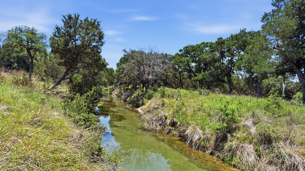 This 10.036-acre property, known as Lot 67 Phase 4 in Rio Escondido Subdivision in Evant, Texas, features approximately 300 feet of Dry Branch Creek frontage along with nearly 100 feet of elevation change that provides beautiful long-range views. The land offers mature trees throughout the property with an open area toward the back that would make an ideal homesite or weekend cabin retreat. Electricity and fiber-optic internet are available at the property, making it an excellent option for full-time living or remote work, while a water well will be needed to complete utilities. Located in a quiet rural setting within Evant ISD, the property offers a slower pace of life while still being conveniently located approximately 30 minutes from Hamilton, Gatesville, Goldthwaite, and Lampasas, and about an hour from Brownwood, Temple, Waco, Killeen-Copperas Cove, and Stephenville. With its central location, mature tree cover, scenic elevation changes, and access to modern utilities, this property presents an excellent opportunity to build, invest, or enjoy your own slice of the Texas countryside. Property does currently have wildlife exemption.