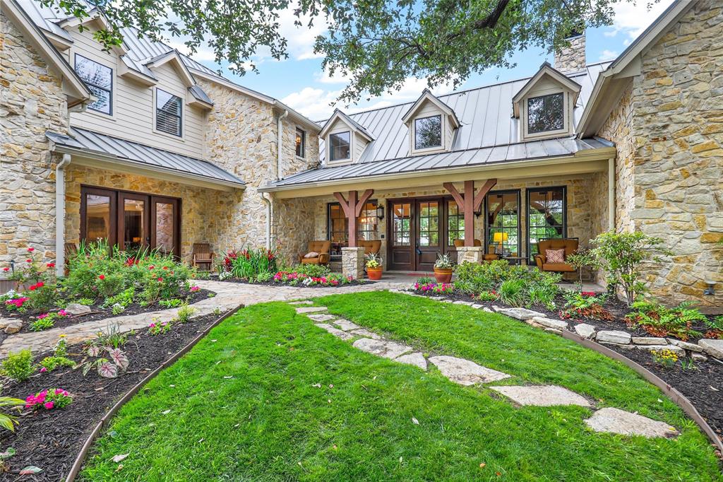 Magnificent lakeside living! This enchanting 5-BE 5.1 BA, 3-CAR custom-built Granbury oasis has it all. Lush landscaping & panoramic sunset lake views set tone for luxurious waterfront dream home w massive porch, patio & lake views from every room. Impressive cathedral ceilings w stunning wood beams wow in Great Room while cozy loft overlooks space. Gourmet Kitchen w built-in fridge, dbl ovens & ample, hidden storage in island. Built-in shelves & desk surround billiard room w hideaway office space. Thermostat & ensuite BA in every BE. Massive Game Rm w vaulted ceilings, currently being used as 6th BE. Oversized Bunkroom w living & dining space! Two staircases. Entertainer’s delight w massive back patio w main body water views. Serene grounds w pool, sport court, trampoline, pergola & firepit w seating. Easily fit 10 cars in drive & garage. All outdoor areas & Dock fitted w spider & mosquito misting system. Creek runs alongside east side of property creating scenic waterfall views.