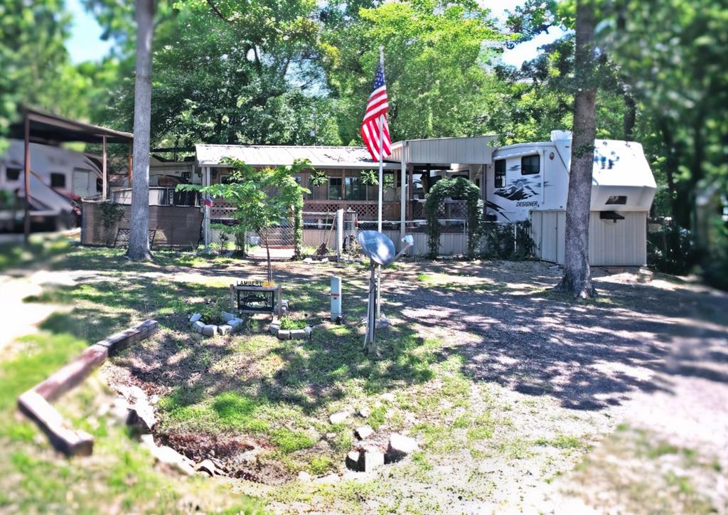 Located across the street from World Famous Lake Fork, this could be the ideal weekend place. Sitting across from thecommunity boat ramp and pier, this property features a circular driveway and a fenced yard for your pets. Included with thesale is a 2008 Jayco Designer 5th Wheel, in excellent condition with skirting and decking leading to the new buildingaddition. The building addition, completed in 2024, has full length wrap around decking with covered front porch, living-bedroom combo with lots of windows, closet with sliding barn doors, washer and dryer connections, a full-size bathroom anda mini split AC-Heat. Property is located in Yantis Tx in the gated subdivision of White Oak Shores, a Lake Fork Community.This HOA has a community boat ramp and pier, swimming pool, picnic tables, playground and club house with plenty ofactivities for the entire family. This is a great fishing place for weekend retreats, and you have plenty of space for family orfriends. Buyer to verify any and all information.