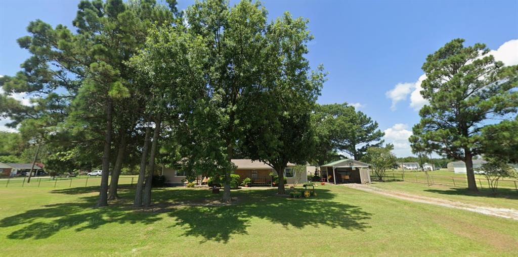This quaint 2-bedroom, 2-bath home sits on nearly one acre and features a beautiful, park-like setting with towering pine trees and plenty of space to enjoy the outdoors.  The home offers a functional layout, solid construction, and traditional exterior—ready for updates and your personal vision. A detached workshop and additional carport provide added flexibility for storage, hobbies, or projects.  Conveniently located near Lake Tawakoni State Park, with easy access to hiking, camping, and renowned fishing.