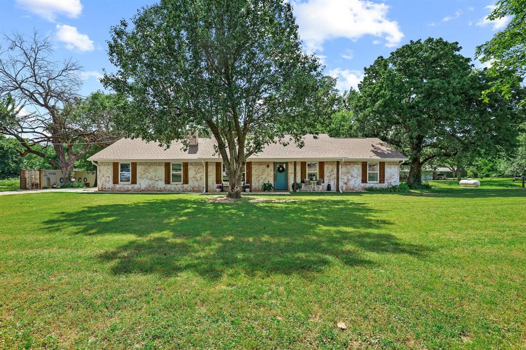 Beautifully remodeled 3-bedroom, 2-bath brick home nestled on just under 2 acres in northern Fannin County, located north of Bonham and just minutes from both Lake Bonham and Lake Bois d’Arc. Surrounded by gorgeous mature shade trees and a beautifully maintained lawn, this property offers the perfect blend of comfort, space, and country charm.
Inside, you’ll find an inviting open floor plan featuring hardwood flooring, updated countertops, and refreshed cabinetry throughout. The spacious layout creates a warm and functional atmosphere ideal for both everyday living and entertaining.
A metal shop provides excellent space for storing your lawn equipment, extra vehicle, boat, or camper. With no known restrictions, the property offers flexibility and freedom that’s hard to find.