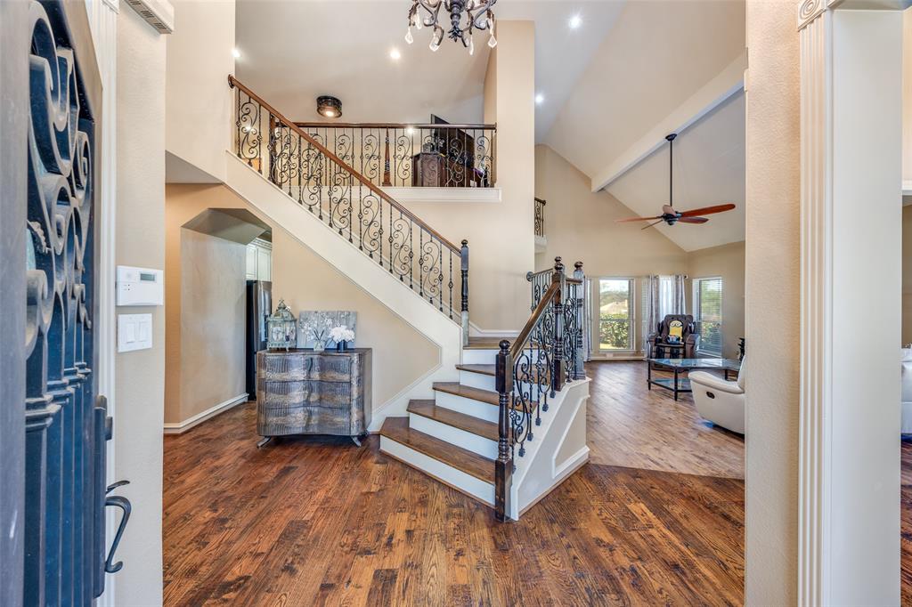 Welcome to this exceptional, Updated home in the highly sought- after Oak Creek estate in Carrollton. This elegant two-story residence greets you with an iron front door, soaring ceilings, luxurious chandeliers and hand scraped natural hardwood floors. the thoughtfully designed layout features two spacious living areas, both with updated fireplaces. the formal living room can easily be converted into a flexible space for additional family entertainment, a media room or a hobby room. the kitchen showcases meticulous attention to detail, featuring arctic granite countertops, a custom backsplash, vintage-style cabinetry with upgraded crown molding, a stunning chandelier and much more for family's chef. The oversized primary suite offers a comfortable sitting area, a large walk-in closet, granite vanity tops, beautifully framed mirrors , a renovated shower booth, and designer's light fixtures. A black iron baluster railing and wood staircase lead to the second floor, where you will find three additional bedrooms, two bathrooms and a game room. providing plenty of space for an extended family. Step outside and enjoy the backyard paradise. perfect for sizzing Texas summer. Oak creek tennis park is just a few steps away, and the home is conveniently located within 10 minutes of GBTP, with easy access to shopping and dining. THIS HOME COULD BE PERFECT FOR YOUR FAMILY!!!