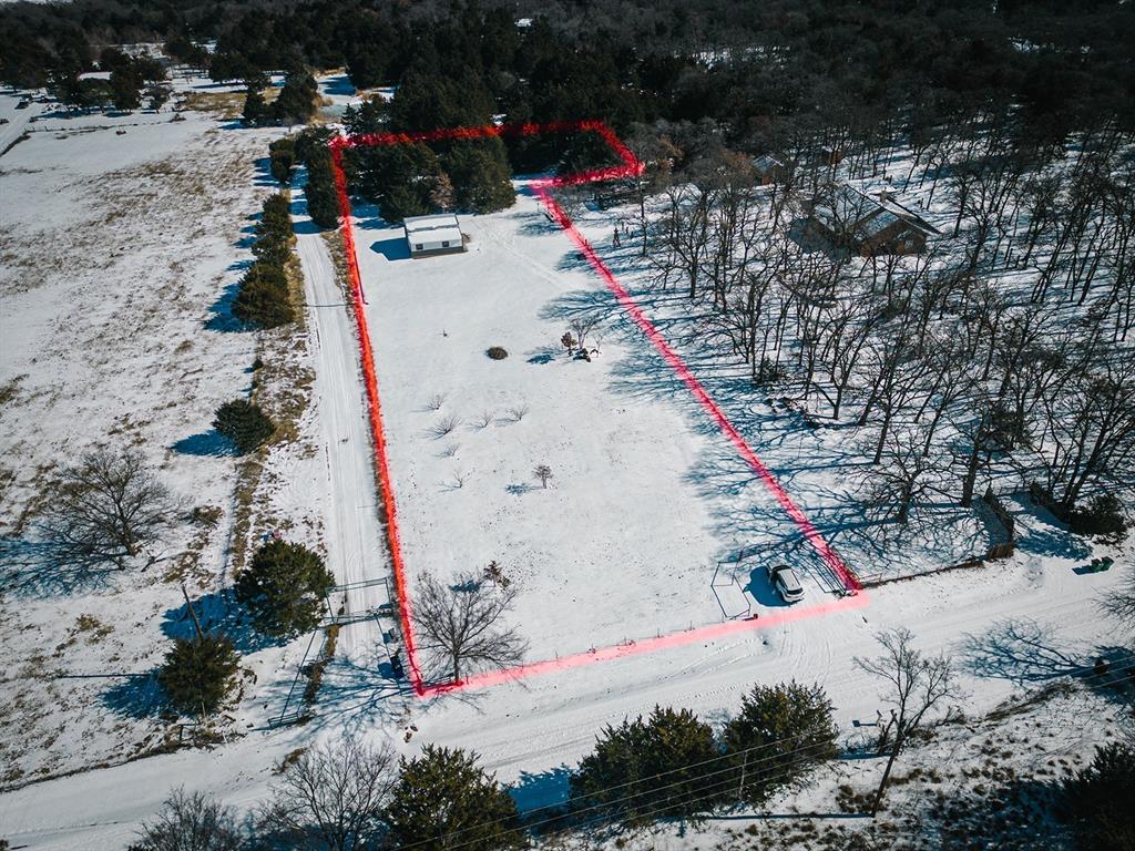 This cleared and fenced property offers an ideal homesite with power, water, and a 200-amp meter box already installed — providing more than enough capacity to support both a future home and a workshop. A brand-new 900 sq. ft. barn is ready for storage, equipment, or immediate use. Enjoy a picturesque mix of open pasture and mature trees, thoughtfully split for versatility. The land sits on a gentle hillside overlooking a peaceful small valley, creating a beautiful backdrop for your dream build. Peach trees add charm and character, while the blacktop road offers easy access in all seasons. Located just 5 minutes from the Lake Ray Roberts boat ramp, this property is perfect for outdoor enthusiasts, hobby farmers, or anyone seeking quiet country living without sacrificing convenience. Whether you’re looking to build now or invest for the future, this turn-key property is ready for your vision.