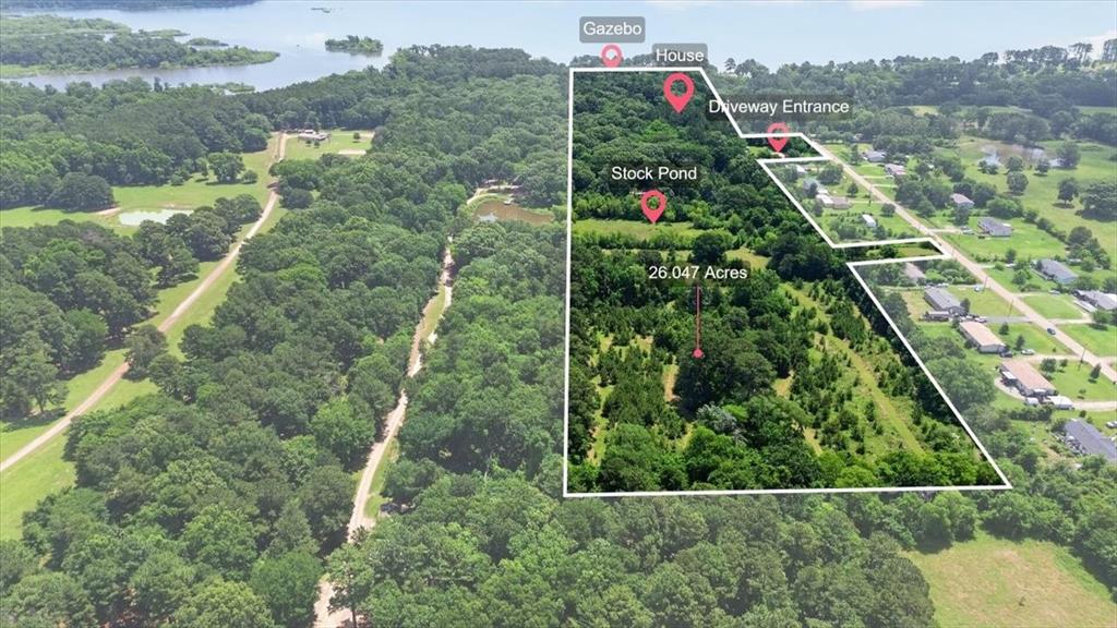 Create the next premier destination on Lake Palestine. Spanning approximately 26 ag-exempt acres with roughly 600 feet of shoreline, this rare waterfront offering presents endless possibilities for investors, developers, entrepreneurs, or those seeking to establish a private legacy estate. The property features a modern lakeside residence, waterfront gazebo and pier, stock pond, public water, electric service, and a private trail system winding through mature East Texas timber. From a boutique resort, luxury cabin retreat, RV destination, wedding venue, wellness retreat, or income-producing short-term rental community to a multigenerational family compound, the canvas is already in place. Large-acreage waterfront tracts of this scale and flexibility rarely come to market, making this one of the most compelling development opportunities currently available on Lake Palestine.
