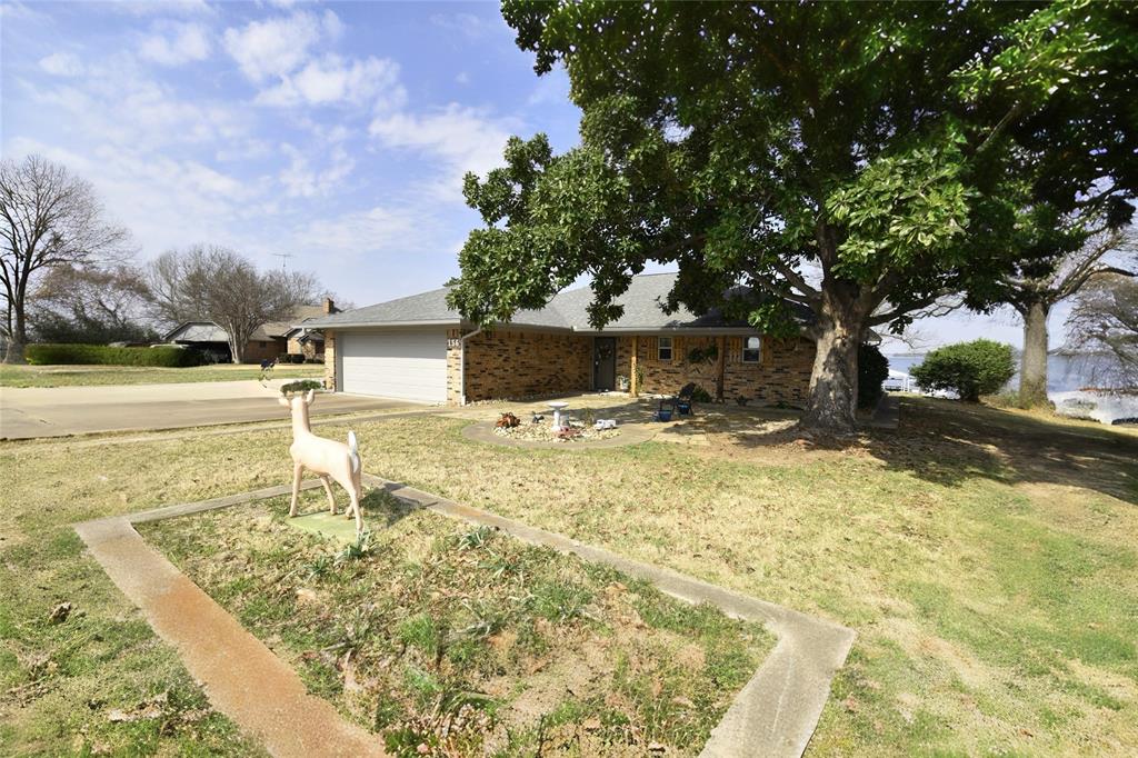 Looking for a Lake Fork home with deep main lake waterfront? Sitting in a small, but friendly subdivision, this Lake Forkwaterfront brick home sits on a .527 acre lot has gorgeous main lake views. Home features 3 bedrooms, 2 bathrooms,granite counters, covered front porch, open back patio area, brick wood burning fireplace and a 16' x 18' enclosed glass sunroom with ceramic tile and it's own A-C. And look at those million dollar views! There is a 25' x 21' two car attached garage, a 25' x 40' insulated workshop perfect for your boat and all your toys! Leaseback property permit is approximately 120 dollars per year, approximately 151' of shoreline with a 2 stall boat house with lifts and covered decking. Property also has a Frenchdrain system in front, new hot water heater installed in 2022, new roof in 2023 and a new A-C unit in 2024. See Transactipon Desk for full list of repairs or there is a photo as well. Buyer to verify any and all information.