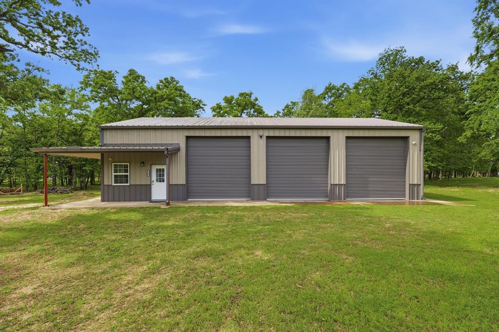 Build your dream home on this exceptional 1 acre deeded property with an additional 1.5 acres of Sabine River Authority leaseback land, featuring a 2,000 square foot Mueller metal building, in the sought after Nautical Shores community on Lake Tawakoni. Positioned on a peaceful protected cove, this corner lot offers a rare opportunity to create your ideal lakefront retreat surrounded by mature trees and calm waterfront views. The expansive 1.5 acre leaseback land provides direct access to the water and includes your own private concrete boat ramp, making it easy to enjoy boating, fishing, and lake days right from your property. The homesite is ready for construction with city water and electric already stubbed along with a septic system sized for a 3 to 4 bedroom home. Bring your own builder and design a custom home tailored to your lifestyle. No manufactured homes permitted. Minimum build requirements are 1,200 square feet for a one story and 1,800 square feet for a two story. The 2,000 square foot Mueller metal barndominium is already in place, complete with a living area featuring a kitchen with granite countertops, stovetop and dishwasher, a full bathroom with shower, and a loft ideal for a bedroom. The shop area includes three 10 by 12 overhead doors, polyaspartic coated floors, 220 volt outlet for tools & machinery, a 50 amp RV outlet, and is pre wired for an additional 220 volt mini split. Additional RV dump station already installed. Residents can also enjoy access to a gated community marina with a boat ramp and covered slips available for rent. Conveniently located approximately 25 minutes to Greenville, 45 minutes to Rockwall, 1 hour 10 minutes to Dallas, and 1 hour 20 minutes to DFW Airport.