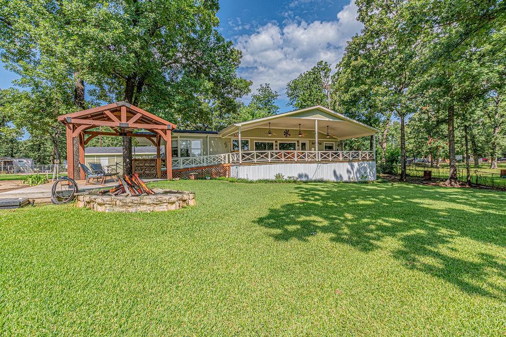 Lakefront Living at Its Best. Peace, Privacy & Plenty of Perks. Welcome to your dream retreat on the water! Nestled in a quiet neighborhood, this beautifully maintained 3 bedroom, 2 bathroom home offers the perfect balance of relaxation and functionality on a stunning  Cedar Creek Lake waterfront property.  Water is supplied by Community Water in Corsicana.  Enjoy breathtaking lake views from your covered porches surrounded by lush landscaping and mature shade trees. Spend your mornings fishing from your private dock, complete with a boat lift and a charming fish cleaning house featuring its own half bath. The home features many new updates including new roofing on all structures, as well as exterior paint, and new timber on the boat dock. Whether you're casting a line or cruising the lake, this is outdoor living at its finest. Inside, the home boasts a fresh and charming feel with an updated interior.  The primary bath and bedroom are a relaxing retreat. The spacious laundry room includes room for a freezer, and thoughtful touches throughout the home make everyday living a breeze. You won't believe the view from the huge picture windows! There's no shortage of storage or space for hobbies, with an oversized 4.5 car garage, separate storage shed, and dedicated RV parking equipped with sewer, water, and 50-amp service. Gardeners will love the roses, peach trees and thriving blackberries, while entertainers and nature lovers alike will appreciate the serene setting. This is more than just a house—it’s a lifestyle. Schedule your private tour today and discover everything this lakefront gem has to offer.  Buyer or buyer's agent to verify all info.