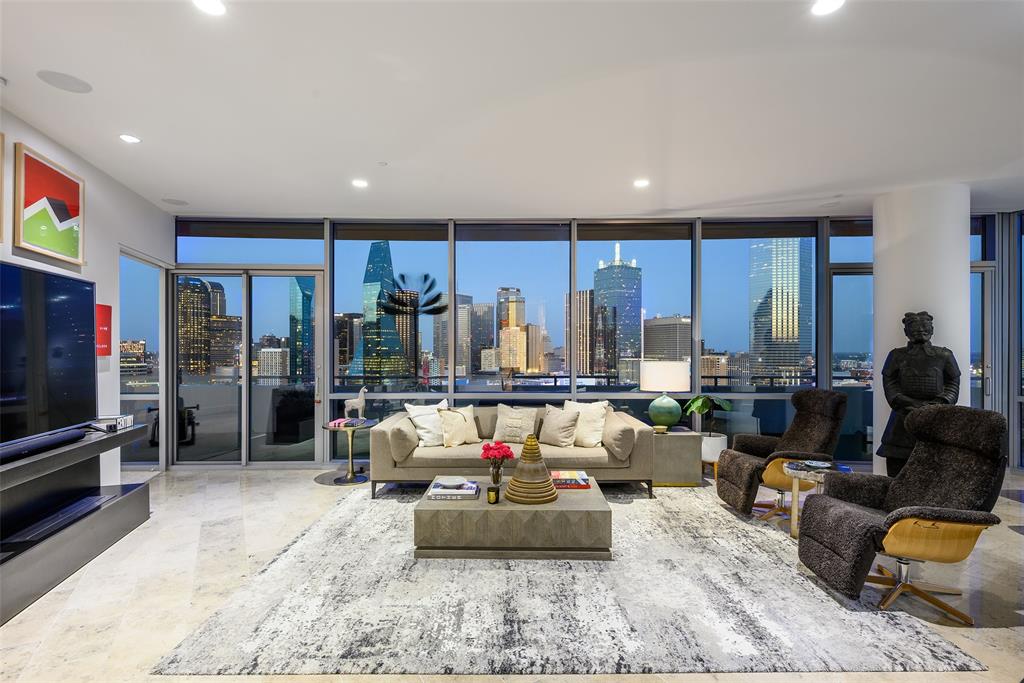 One of a kind, this exceptional custom residence combines two homes into an expansive and thoughtfully designed living experience unlike any other at The House Condos, the iconic Philippe Starck-designed high-rise in Victory Park. Positioned on the coveted southeast corner, dramatic walls of glass showcase commanding panoramic views of the Dallas skyline, while clean architectural lines, custom-crafted finishes, and meticulous craftsmanship define every space.
Thoughtfully customized with uncompromising attention to detail, this residence offers timeless sophistication. The kitchen features sleek Italian cabinetry and Miele appliances, including refrigerator and freezer, induction cooktop, steam oven, wine refrigerator, and a pantry.
The luxurious primary suite is a private retreat with a spa-inspired bath featuring dual vanities, soaking tub, expansive walk-in shower, and 300-square-foot closet. A generously sized secondary primary suite offers a beautifully appointed ensuite bath, while a third bedroom with a private bath provides flexibility for guests, a media room, or office.
Refined finishes include limestone and white oak flooring, museum-finish walls, fireplace, lighting, and a Lutron automation system controlling lighting, sound, and motorized shades. The 672-square-foot terrace extends the living space outdoors.
A versatile second living area showcases a glass-enclosed wine display and offers flexibility as a study or lounge. 3 premium parking spaces, including an EV charging station, convey with the residence.
Residents enjoy resort-inspired amenities including a 130-foot saline pool, spa, fitness center, owners’ lounge, guest suite. Services include 24-hour concierge, valet, security, package delivery. Ideally located in Victory Park, one of Dallas’ most dynamic and evolving neighborhoods, this residence offers a front-row seat to the city’s expanding business and cultural landscape, including the continued growth of the Dallas financial district.