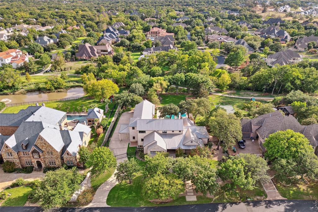 Modern masterpiece built by Simmons Custom Homes in Westlake's gated Glenwyck Farms!  Gorgeous private setting situated on over an acre treed lot backing to a greenbelt with views of a neighboring pond!! Stunning architecture designed by Bernbaum Magadini. Inviting entry, designer lighting, and attention to every detail. Chef's kitchen features a large center island, high-end appliances, butler's pantry, and spacious breakfast area with a see thru fireplace. The master suite offers a private sitting area overlooking the backyard oasis, a spa-like bath, exercise rm & custom closets. Downstairs also features a large versatile Great room with dining room, spacious family room, executive study & a guest suite with private bath. The 2nd floor offers a bonus room, a game room with wet bar, and 4 large bedrooms each with ensuite baths. The outdoor living space is perfect for year-round entertaining featuring a fireplace, auto screens, & overlooking the sparkling pool, spa & spacious backyard.