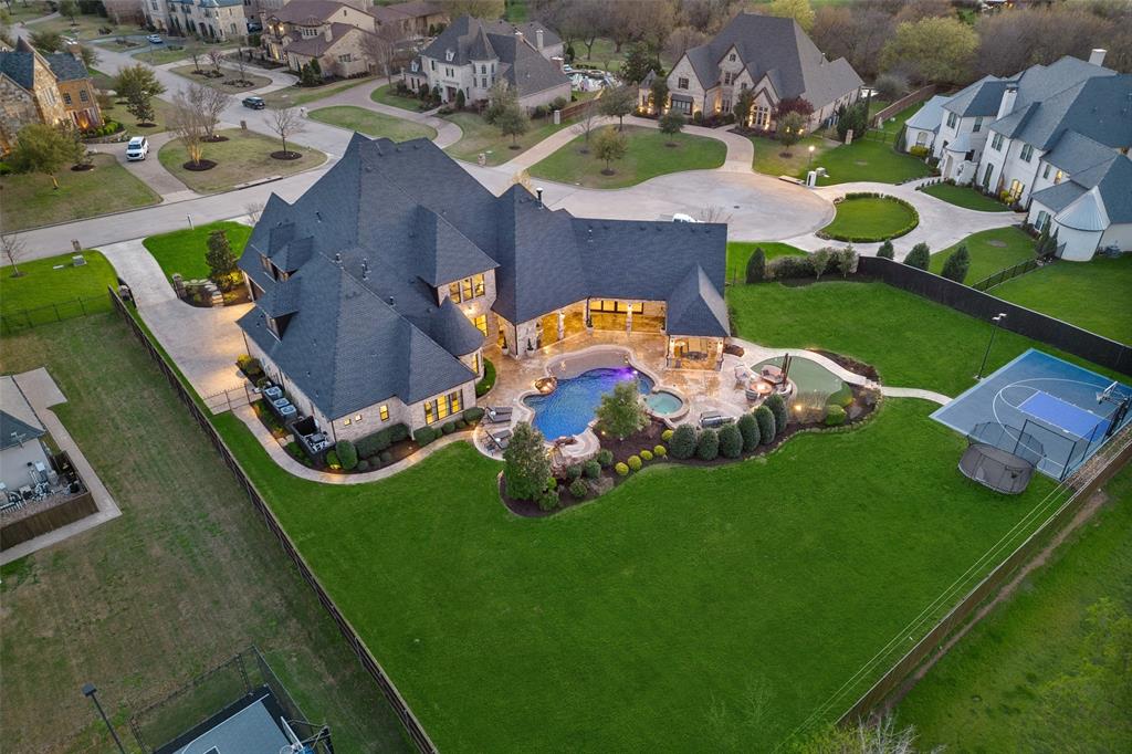 Stunning updated custom home on 1 acre lot in the heart of Southlake.  This elegant home offers a harmonious blend of luxury and comfort, boasting 6 bedrooms and 6.2 bathrooms. Upon entering, you are greeted by a grand foyer that sets the tone for the rest of the home. The interior is adorned with impeccable attention to detail and showcases an abundance of upgrades. The layout effortlessly flows from the gourmet kitchen to the spacious living areas, creating an ideal setting for hosting gatherings and creating memories. Impressive Temp control wine room. First floor features top-of-the-line golf simulator or media room, game room with bar and workout room. Oversized secondary bedrooms with ensuites. Stunning outdoor paradise with fireplace, grilling kitchen, fire pit, sports court, putting green, and incredible resort style pool.  Mosquito system, epoxy garage floors and so much more. Roof replaced 2021, Windows replaced.