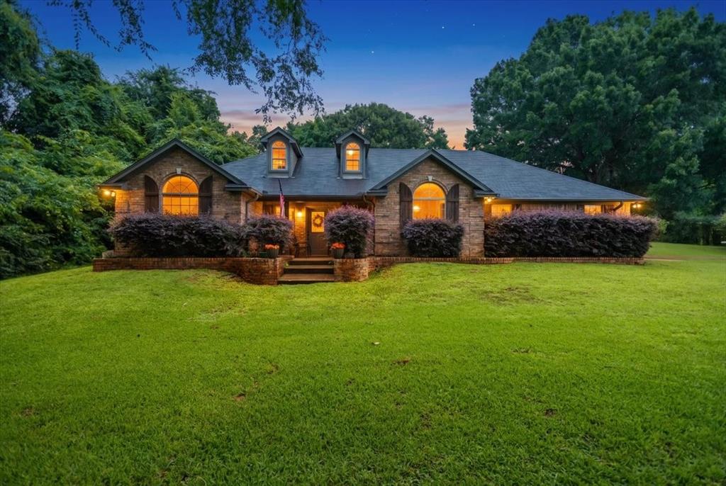 Welcome to your peaceful East Texas retreat. Nestled on a generous 1.14 acre corner lot just outside the Jacksonville city limits yet less than a mile from the city golf course, this beautifully updated, 2,077 square foot brick home offers the perfect blend of country freedom and modern comfort. Built in 1996 on a solid slab foundation, this spacious 5-bedroom, 2-bathroom property is ready for its next chapter. Step inside to an inviting living room that serves as a warm, welcoming gathering space, featuring soaring vaulted ceilings and a cozy wood-burning fireplace perfect for crisp evenings. Kitchen flowing seamlessly from the living area. Centrally located in the heart of the home, it boasts trendy butcher block countertops, an abundance of storage, and an ideal layout for entertaining family and friends. The master suite is a private sanctuary designed for ultimate relaxation. It features an elegant accent wall, sophisticated tray ceilings, and peaceful views overlooking the backyard pool. The attached en suite bathroom is fully equipped with double lavatories, dual walk-in closets, and shower tub combo. With four additional dedicated bedrooms, the home offers incredible flexibility, making it easy to accommodate a growing family, a home office, a gym, or a hobby room without sacrificing space. The outdoor features of this property are just as impressive as the interior. Enjoy the freedom of living outside the city limits on a spacious corner lot with plenty of elbow room. Summer days are best spent in your private backyard oasis, which features an underground chlorine pool perfect for cooling off and entertaining. The 1.14 acre grounds also include a handy storage building for tools, toys, or lawn equipment. This nicely updated, move in ready gem offers the tranquility of rural living while remaining just minutes from downtown Jacksonville amenities. Schedule your private tour today and come see everything 139 CR 4217 has to offer.