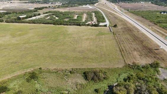 Introducing a prime 32 acre parcel with 894 feet of frontage along the prestigious Chisholm Trail Parkway, conveniently located on the Cleburne and Joshua border. The front 4.5 acres are nestled within the Cleburne city limits, providing unique development opportunities.This exceptionally level property is ideal for both commercial development and industrial use. Don't miss this rare chance to acquire a stunning piece of land with immense potential. Seize the opportunity today!