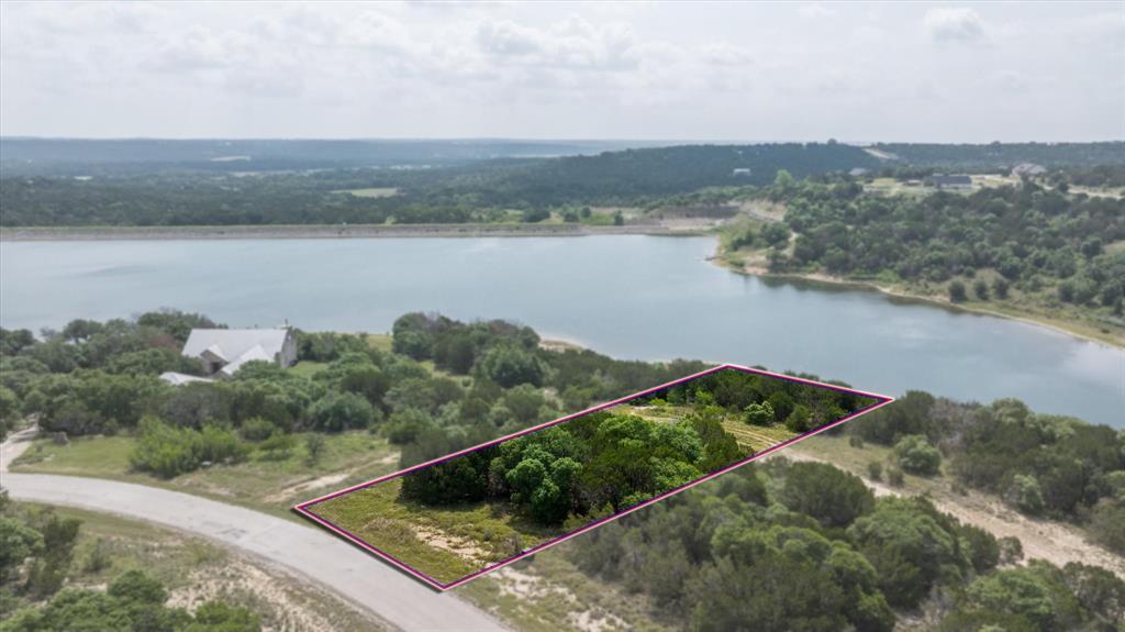STUNNING 1.16-ACRE LAKEFRONT LOT IN THE PRESTIGIOUS MOUNTAIN LAKES COMMUNITY! Bring your own builder and design your dream home on this premium, oversized waterfront lot nestled in the rolling hills of Bluff Dale, TX. This property offers the rare combination of generous acreage, mature trees, and direct water access, providing breathtaking panoramic views and ultimate privacy.
Mountain Lakes features top-tier community amenities, including two private lakes one recreational, one fishing, a community pool, club house, pavilion, park, playground, and an RV park storage area. Enjoy the peace of Texas Hill Country living with an easy commute to Fort Worth, and quick access to nearby Granbury and Stephenville. Don't miss this incredible opportunity to own a slice of Texas paradise!
