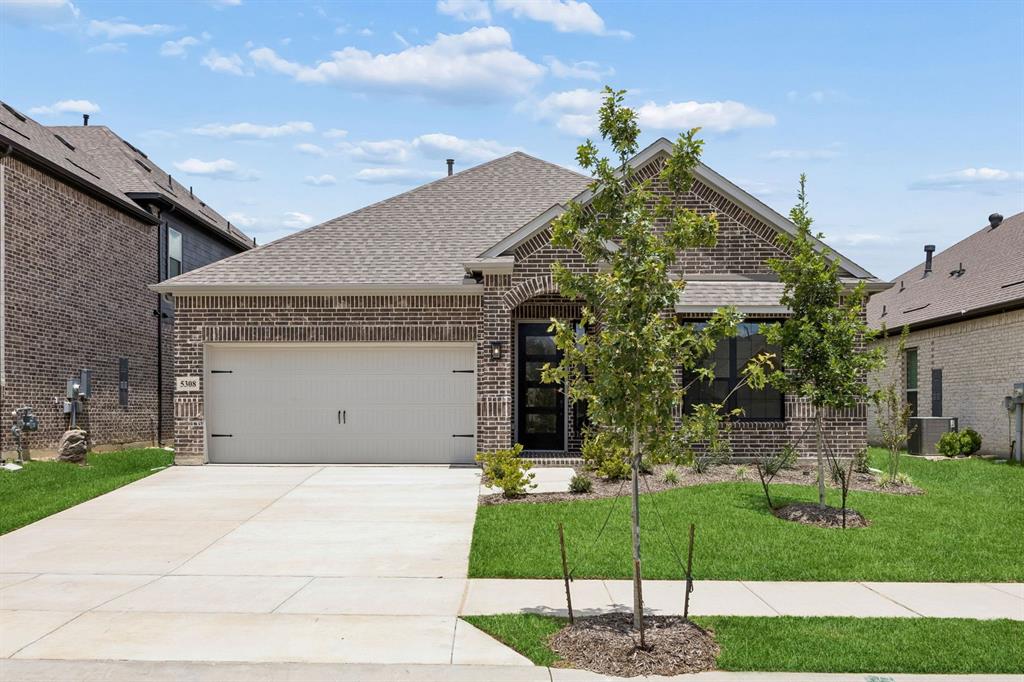 MLS# 21198410 - Built by Sandlin Homes - Ready Now! ~ Discover a stunning single-family residence in the master planned Country Lakes community, set to be completed by Spring 2026. This traditional home features 4 spacious primary bedrooms and 4 bathrooms, offering ample space for comfort and privacy. With 2,543 square feet of thoughtfully designed living space, the layout includes 2 inviting living areas, a dining room, and a cozy fireplace, perfect for entertaining.  Enjoy outdoor living on the covered patio, surrounded by a private yard. Additional highlights include the upstairs game room with a half bath and bay windows in the primary suite, perfect for seating or plants. Throughout the home, many contrasting black and white elements highlight the primary bathroom, utility room and fireplace. The modern kitchen is complemented by its dark cabinets and bright quartz countertops with pops of gold in the cabinet pulls and kitchen faucet.