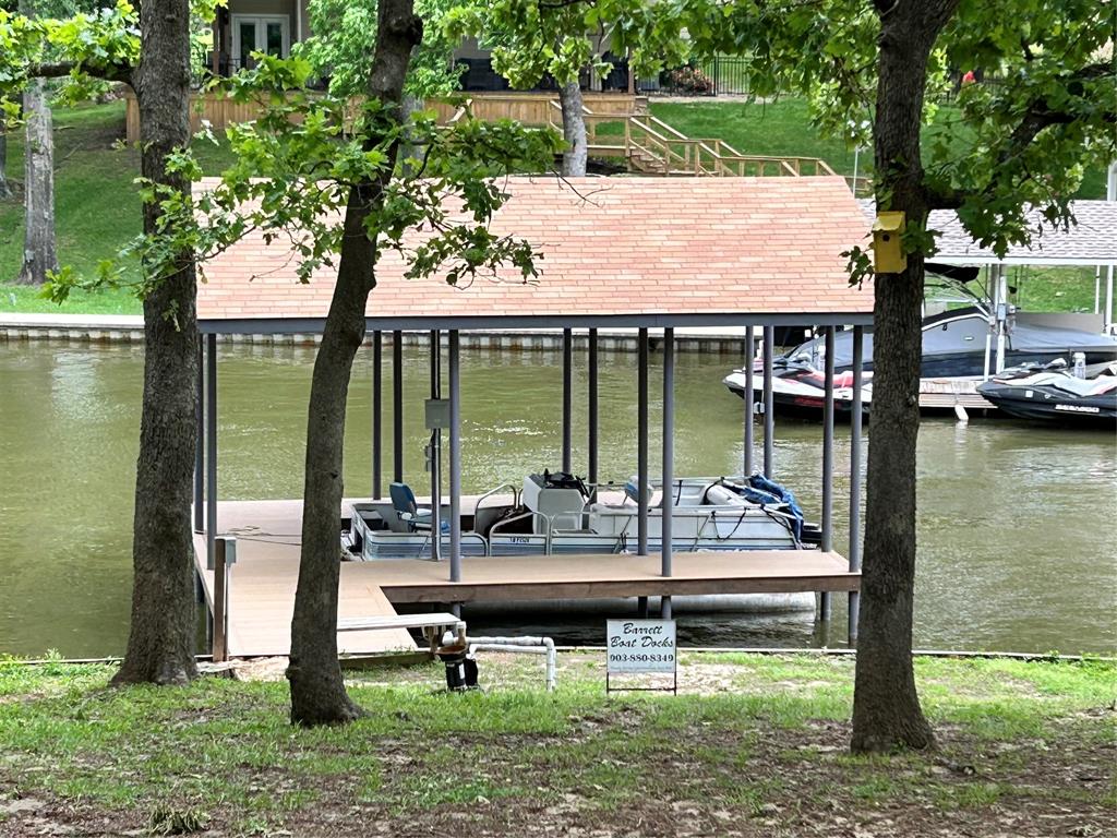 Fully Furnished .42 acres approx  features 140 approx water front with retaining wall at the point of 2 channels with newer boat slip. The fishing from the pier is excellent.  Ideal location for other water sports like canoeing, paddle board, kaying because there are many fingers off the main channel.  The home has lots of updates and fantastic views of the channel & nature. The entire back of the home is a wall of windows. Primary bedroom has ensuite bath, king bed. 2nd bedroom has bed & shares bath with living room. HVAC, water heater, ext siding, concrete flooring, ext & int paint, and a few windows are more recent.  2nd living room has WB fireplace.  Point LaVista Hoa offers owners use of the boat ramp, little private lake, swimming pool, tennis. hoa per lot is currently $150 HOA does not allow short term rentals.  Stack washer dryer closet. 18 ft older pontoon neg Things we Love about this home: wildlife incl beaver, owl, flying squirrel, coatimundi, fox, armadillo, cormorant chasing shad, blue & wht herrens, ducklings; walking the neighborhood because its filled with oak trees & smells great, the neighbors. Agent Owner