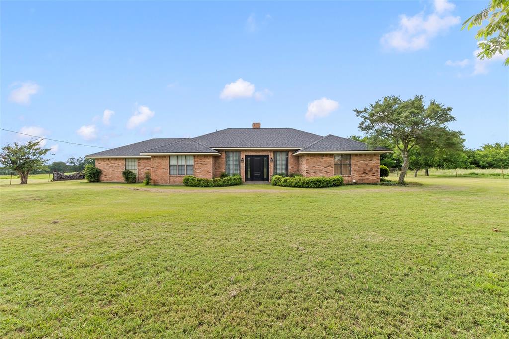Stunning 11-Acre Custom Country Estate in Kaufman! Welcome to your dream rural retreat! This unique property offers a rare combination of comfortable country living and expansive open land, spanning two parcels for a total of 11 pristine acres featuring a 1-acre homestead parcel and a 10-acre agricultural tract. The focal point of the estate is a sprawling 3,226 sq. ft. custom-built, single-story brick farmhouse built in 1990. The beautifully designed layout offers 3 spacious bedrooms, 2 full bathrooms, and 2 distinct living areas anchored by a cozy wood-burning fireplace, creating a warm and inviting atmosphere. A standout feature for animal lovers is the  dog kennel complete with a fenced-in dog run located right in the back yard. The exterior features a massive 1,351 sq. ft. covered porch perfect for enjoying breathtaking Texas sunsets, along with a 660 sq. ft. attached garage and an 800 sq. ft. outbuilding storage shed. The acreage is a true  farm setup, fully fenced and cross-fenced with high-quality barbed wire and chain-link fencing. It features a beautifully maintained hay meadow optimized for production, improved pastures, beautiful mature shade trees, and active ag-exempt status to keep your taxes low. Equipped with a private septic tank and community water via Becker-Jiba Water Co-Op, this property is perfect for your agricultural ventures. Don't miss this incredible opportunity to own a slice of Texas paradise!
