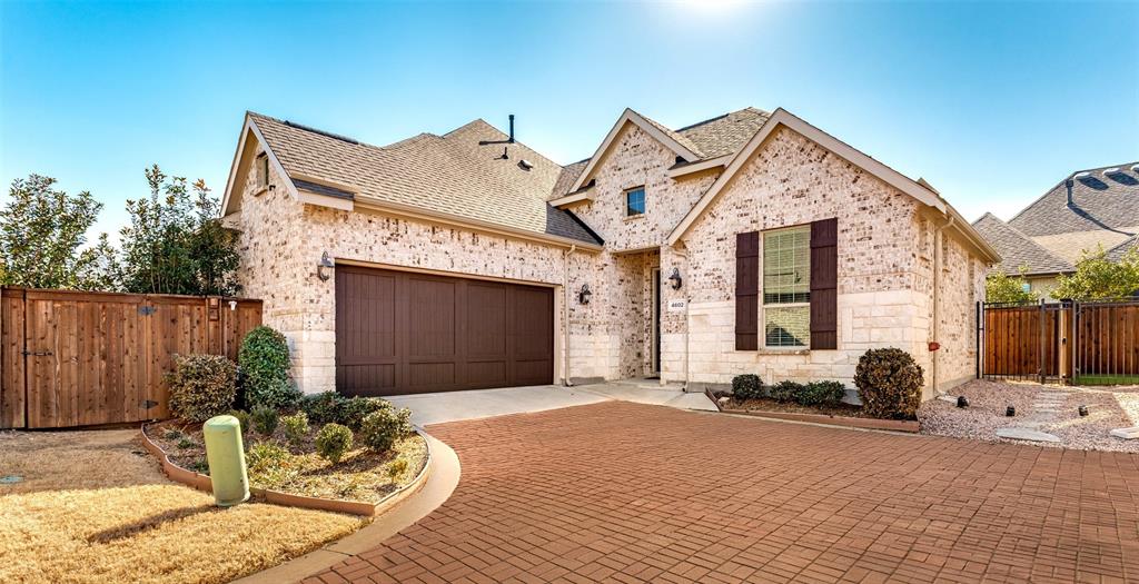 Adult 55+ community.  This extremely well-maintained, nearly new home truly showcases pride of ownership with no deferred maintenance. Designed for effortless living, it features a low-maintenance exterior and sophisticated custom interiors throughout. The open floor plan is enhanced by 8-foot doors, custom paint, and striking waterfall kitchen cabinetry, creating a modern yet welcoming feel. The chef’s kitchen boasts quartz countertops, 42-inch upper cabinetry with crown molding, stainless steel appliances, and a double oven—perfect for everyday living and entertaining. The spacious laundry room offers ample storage and space for a freezer. Both guest and primary baths are beautifully appointed with quartz countertops and undermount sinks, while the primary bath includes a double shower with bench seating and a quartz vanity counter top. Energy efficiency and comfort are top priorities with triple-coated Low-E, floor-to-ceiling vinyl windows throughout, a 16 SEER-rated HVAC system, roof ridge ventilation, and a Q Fresh air supply system. Additional upgrades include toggle light switches, an insulated cedar double garage door that leads you into your oversized garage. Step outside to enjoy a large covered patio overlooking a private, board-on-board privacy fence with a tree-lined backdrop—ideal for relaxing or entertaining. Beyond the home, residents enjoy access to the award-winning Magnolia Lifestyle Center featuring a demonstration kitchen, fitness center, elegant gathering spaces, and a covered terrace and sun deck overlooking a stunning infinity-edge pool. The community also offers pickleball courts, a putting green, multiple fire pits, and full access to Viridian’s renowned amenities, including play parks, dog parks, landscape gardens, sculpture gardens, lakes, and additional pools Fridge, Washer and Dryer will convey with property. MOVE IN READY