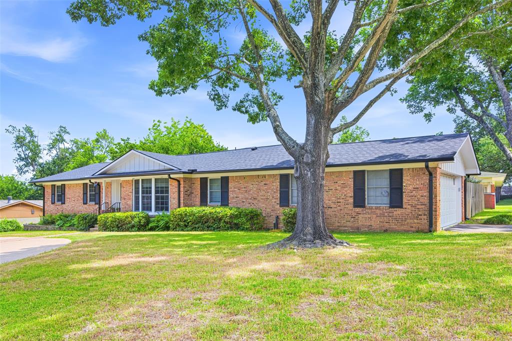 Come see this beautifully remodeled home in the heart of Tyler - near Green Acres Church - with 3 possibly 4 bedrooms on a corner lot. It was thoughtfully renovated by its owners in 2022 with too many upgrades to mention here, but we'll try. Living room features a dramatic vaulted cedar ceiling, stone fireplace with wood mantel, custom lighting, custom window framing, woodwork and blinds and an oversized fan. Gorgeous gray ceramic tiles flow seamlessly into the formal dining room with new light fixtures, wainscoting, bay window, and a dedicated home office (or 4th bedroom) with sliding barn door. The Chef’s Kitchen shows off with its white shaker cabinetry (custom made) with glass uppers, a contrasting blue island with granite countertops, Samsung stainless steel appliances, a gas range with a pot filler, and a butler’s pantry with a custom built-in china hutch. And the breakfast nook offers a casual dining space with a large corner window, tray ceiling and candelabra lighting. Laundry room features a mudroom or catch-all space, new cabinetry and a farm sink. Even the garage was touched with a new door and motor, epoxy flooring and a whole-home water filtration system.The primary suite boasts a tiered cedar ceiling, walk-in closet, and enter the sliding barn door to find a spa-style bath with marble counters, walk-in shower, ceramic tile & custom made cabinets. The covered back patio overlooks a fenced backyard with mature trees, a stone outdoor fireplace, and storage shed. Minutes from Loop 323, US-69, close to TJC, and Tyler's medical corridor including CHRISTUS Mother Frances Hospital and UT Health East Texas — with easy access to Bergfeld Park, the Tyler Rose Garden, Caldwell Zoo, and downtown Tyler dining and entertainment. Spray foam insulation added in the attic, circle drive in the front added in 2023, entire home repainted, fresh wood trim - almost every surface has been touched...Better hurry as this astonishing home will not be available for long.