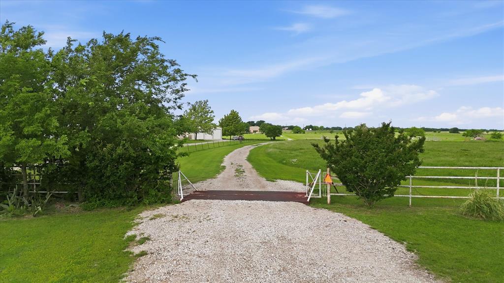 Amazing country home on 19.48 acres in Krum. An updated home with 3 bedrooms, a peaceful covered back porch and enlarged front porch, and an oversized carport with a workspace and RV parking. Foundation work completed in 2022 with transferable warranty, new paint throughout home, new carpet and updated fixtures. With this property you will be far enough outside the City of Krum to enjoy the peace of the country but close enough to Hwy 380 and 1173 to be in Krum within a few minutes and in Denton within 10. The property currently has an Ag exemption in place and space to bring your animals and ideas. For your animals there are cattle guards in place, a pond on the North side of property with Plainview Rd frontage (a small section in the flood zone), and barn with storage space. Three Denton County parcels included in the 19.48 acre listing.
