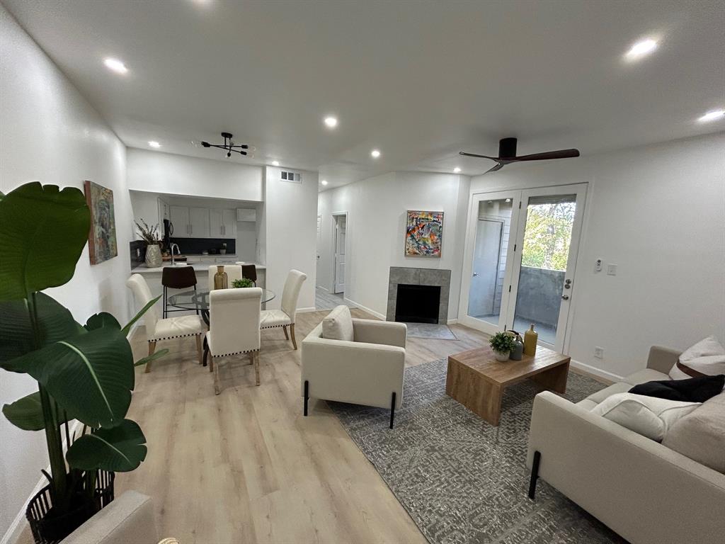 Fully renovated 2 bedroom condo in Dallas with an open, light-filled layout. The living room features tall ceilings, modern flooring, LED lighting, and a wood-burning fireplace. The updated kitchen includes new cabinets, quartz countertops, stainless steel appliances, and a breakfast bar that opens to the dining and living areas.

The bathroom has been remodeled with contemporary tile and a quartz vanity. The primary bedroom offers a large walk-in closet and overlooks the wooded creek. The second bedroom also enjoys creek views and works well as a home office.

A private patio with storage sits off the living room, and a designated parking space is conveniently located near the back entrance.  Comes with stackable washer & dryer!

Great condo for someone looking for their personal home or as an investment!