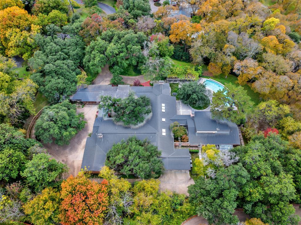Nestled in the exclusive Old Preston Hollow, this midcentury masterpiece, once owned by Dallas philanthropist Virginia Murchison, is a timeless gem.  Renovated by renowned architect Bill Booziotis in 1998 and 2007, the 5-bed, 6.5-bath home spans 9,875 sq ft.  The heart of the residence boasts a spacious living room with floor-to-ceiling windows and an updated kitchen.  The tranquil grounds, sprawled over 2.92 acres, feature an infinity pool and spa, surrounded by mature oak trees.  Additional highlights include a guest suite, game room, and full guest house.  Rare opportunity to own a piece of midcentury elegance.