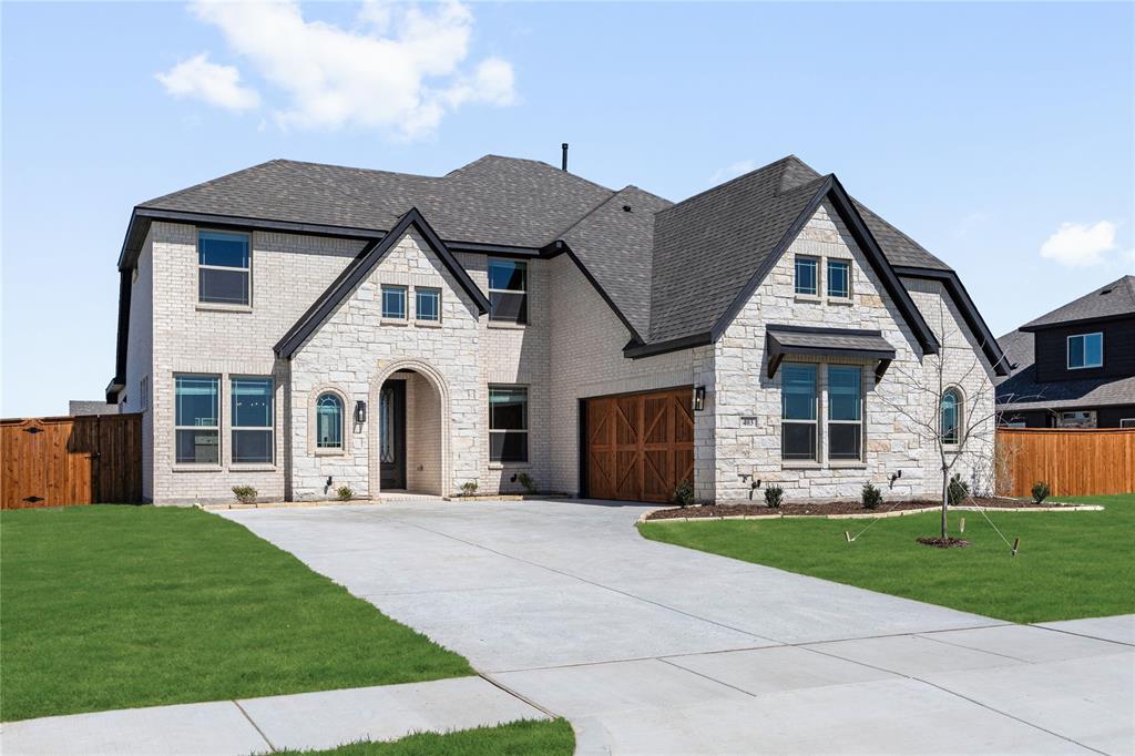 NEW! NEVER LIVED IN. Recently Completed - Bloomfield Homes brings the Seaberry plan to Glenbrook with 5 bedrooms, 4 baths, a study, media room, and game room arranged across a thoughtful two-story layout. Set on a HUGE half-acre corner lot, the home makes an immediate impression with its upgraded white brick exterior, dark trim, and an 8' wood-and-glass front door that introduces the refined palette carried throughout. Continuous wood flooring guides the main level’s flow toward the two-story family room, where an 18' tile-to-ceiling fireplace becomes a dramatic architectural anchor. The Deluxe Kitchen features stained cabinetry, bright quartz countertops, a 5-burner cooktop, double ovens, and pendant lighting over the island. A butler’s pantry links the kitchen directly to the formal dining room, creating a seamless connection between prep, serving and gathering spaces. The first-floor layout positions Bedroom 5 and the media room together in a defined corner, with Bedroom 1 privately set opposite and offering a large walk-in closet plus a bath with a deck-mount tub and separate shower. Upstairs, the plan opens to a central game room connecting 3 bedrooms—each with walk-in closets—and 2 full baths, including a convenient Jack-and-Jill. Upgraded horizontal iron railing along the stairs and catwalk adds clean modern lines, while curated details such as cabinet uppers in the laundry room, patterned tile in the baths, and exterior uplighting elevate the overall design. A standard two-car garage completes the plan, and the expansive half-acre lot offers room to stretch out and enjoy a rare amount of space. Call or visit Bloomfield’s nearby model to explore this Seaberry on a half-acre corner home site.