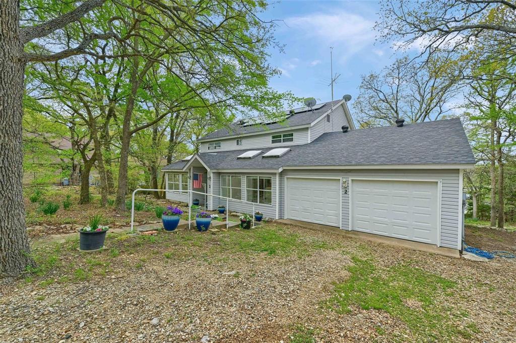 Lake Texoma Retreat with Views of Grandpappy Point Marina!
Thoughtfully designed and meticulously maintained by its original owner, this custom-built home is a true sanctuary for lake life enthusiasts. Backing up to the protected land of the Army Corps of Engineers and perched above Grandpappy Point Marina, the property offers peace, privacy, and is a perfect getaway to the sparkling waters of Lake Texoma. Whether you’re hosting weekend gatherings or savoring quiet mornings on the porch, this home was made for living well at the lake.
Stand out Points of interest:
GE Appliances, Reverse Osmosis Drinking Water, Whole-House Water Softener System,and New Garbage Disposal.
Perfect for cooking up the day’s fresh catch or preparing sunset snacks for friends after a day on the water.
Garage large enough for Texas Trucks! Insulated Garage Door and Epoxy-Coated Flooring.
220 Amp Outlet – Ideal for EV Charging or Workshop Use
Rock Driveway Designed for Natural Drainage.
Solar Panels for Sustainable Living, New HVAC Heat Pumps, New Energy-Efficient Windows and Fresh Interior Paint.
Chair Lift to Second Floor – Designed with long-term accessibility in mind
12x12 Storage Building – Ideal for lake toys, tools, or gardening gear. 
This perennial gardener’s paradise is alive with seasonal color—Jonquils, Hyacinths, and Iris bloom with spring’s first kiss. Shade abounds under the canopies of five species of Oak trees, along with Red Buds and drought-tolerant Desert Willows.
For the nature lover, this home is a front-row seat to daily wildlife encounters:
A flock of wild turkeys often passes through on their seasonal route
Frequent visits from finches, chickadees, wrens, cardinals, and both greater and lesser woodpeckers
And every so often, a bluebird brings its touch of magic
Whether you're an avid gardener, birder, or simply someone who appreciates the serenity of nature, this property is more than a home—it’s a lifestyle by the lake.