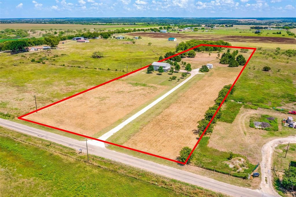 Welcome to this spacious Barndo nestled on a sprawling 6.84 acres of land, offering a serene and private retreat for those seeking a harmonious blend of comfort, natural beauty and convenience.  Located in the highly sought after Grandview ISD school district and offering easy access to I35 for a seamless commute.  The main living room area boast an open concept layout, promoting a seamless flow between the living room, dining area and kitchen.  The kitchen features cabinets and counter space galore!  One of the most exciting aspects of this Barndo is the potential for customization. The top floor of the Barndo is waiting for your personal touch, providing an opportunity to create a dream space that suits your specific needs and preferences. Whether you envision an additional living area, an office, a game room, or an expansive master suite, this unfinished area allows for endless possibilities to fulfill your vision.  The property features a private well & a storage building.