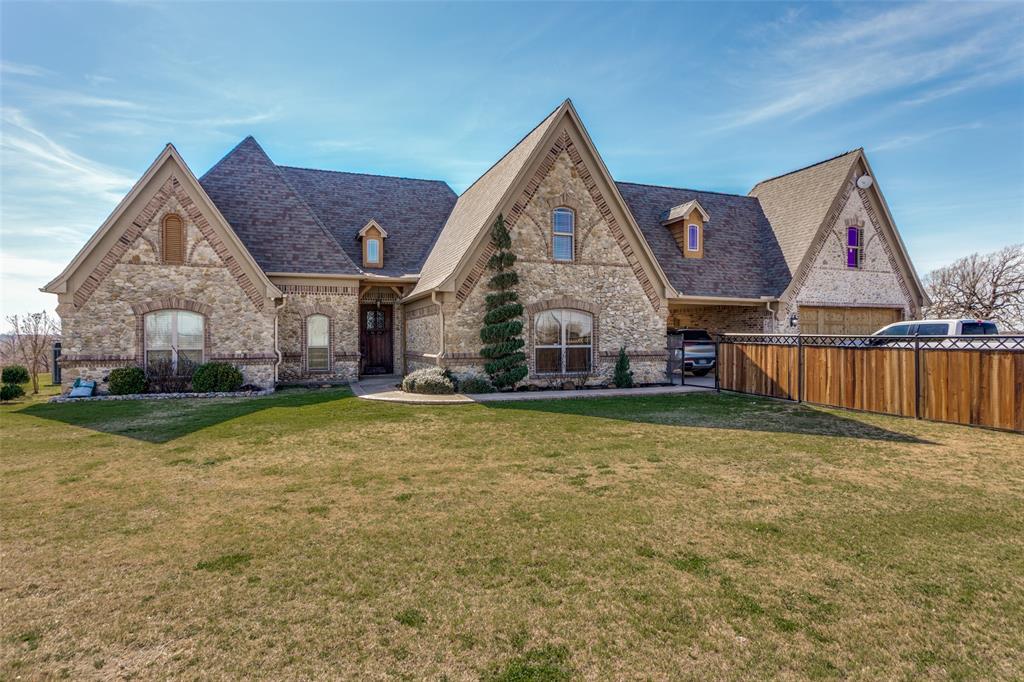 4.94 Acres in Paradise Texas with Pool! 4 beds, 2.5 baths, 2 living and Unfinished Bonus room(s) with HVAC. This sprawling cobblestone Tudor estate has a porte cochere with copper gutters, corbel accents and inlaid stone accents. The custom door welomes you into the grand living room with real wood floors, heavy textured archways and a vaulted beamed ceiling with raised hearth wood burning fireplace. The entertainer's kitchen has a pass through bar, glazed cabinets, walk-in pantry, built-in microwave, electric range w vent hood and tumble marble backsplash. The eat-in kitchen has a large breakfast room with wood-inlaid floors and bar stool seating looking onto the expansive patio. The primary ensuite boasts a tray ceiling, jacuzzi tub, large walk-in shower, dual-sink vanity, and walk-in closet. The split layout affords privacy with two additional beds down - each with direct access to the full bath with shower tub combo. This flex plan has a spacious second living down that could also serve as an in-law suite, playroom, media or grand office suite. Upstairs find an additional bed with half bath and an unfinished bonus suite with hvac. See drawing in transaction desk. Outside enjoy a 15x10 covered patio with vaulted pergola, an open patio, chlorine diving pool with grotto waterfall, bubbler beachfront sun ledge and firepit. Well with Leaf Home Water Solutions Softener. NEW Pool Auxillary Pump Motor, New Filter Pump Motor & Seal Kit and Hayward Omni Hub App Driven Control Panel. New Garage Door and Opener. New Water Softener. NEW Gutters. Newer water well couplings, wire and well pump. 2022 ROOF.
