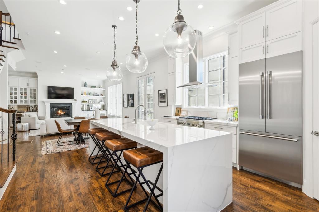 Introducing a one-of-a-kind, Old World-inspired luxury townhome in the heart of Dallas’s vibrant State Thomas neighborhood, where city living meets timeless elegance. Custom-built over two years & meticulously enhanced with upgrades, this Lueders stone masterpiece offers unmatched craftsmanship & privacy, with no HOA or condo fees. Designed with a nod to classic European architecture, the property showcases intricate stonework, wrought iron gates & charming Juliette balconies, creating an atmosphere of sophistication. Spanning four stories, the home boasts 3 light-filled bedrooms, each with ensuite baths, a dedicated office with custom shelves & 2 inviting living areas. The gourmet kitchen is a chef’s dream, featuring Thermador appliances, a dramatic porcelain waterfall island & hand-scraped hardwood floors throughout the open-concept living spaces. Watch the neighborhood come to life as you enjoy your coffee on the Juliette balcony off the kitchen. The luxury continues in the bathrooms, with marble floors & Italian porcelain counters & walls creating a spa-like retreat. The primary suite is a true sanctuary, complete with a cozy gas fireplace & private Juliette balcony overlooking historic Thomas Ave. A private elevator connects each floor for easy access. On the 4th floor, a wet bar complements a large 2nd living room with a spacious covered balcony, perfect for enjoying the Dallas skyline over a glass of wine. The crowning feature of this home is the expansive 600+ sqft rooftop deck, ideal for entertaining or savoring breathtaking city views & firework displays. With tall ceilings and windows throughout, this home offers an airy feel in every room. Steps from Dallas’s finest restaurants, art galleries & nightlife, this property delivers the ultimate urban lifestyle without sacrificing luxury or privacy. A rare opportunity to experience city living at its finest—welcome to your dream home. Make sure to click to see the videos, floor plans and more! No HOA fees