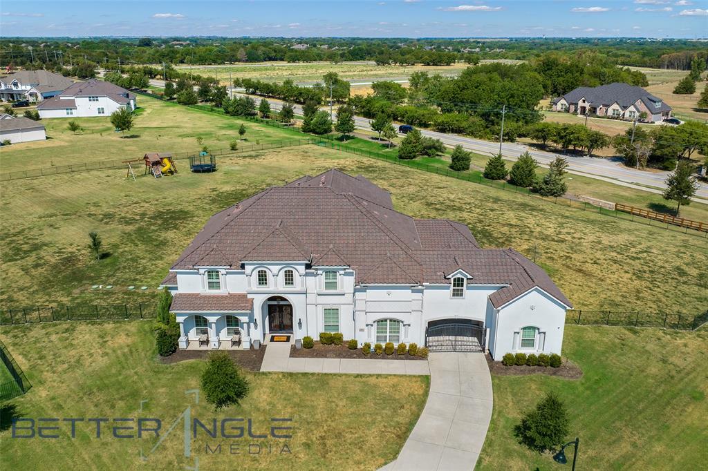 This stunning estate in popular Parkside at Fairview with pool sits on the largest lot in the subdivision, 2.32 acres. Located in highly rated Lovejoy ISD hm includes 5 BRS 4 and a half BA, media, game, formal dining, wine rm, breakfast area, huge laundry rm with island, mud rm and 3 car garages. The sparkling heated pool has a large spa, water feature, tanning ledge, lots of stone decking a covered outdoor kitchen with built in grill and bar. Primary and another bedroom are downstairs. Open floorplan. Primary BR has sitting area a massive on-suite bath with marble flooring, double shower, garden tub, double vanities, make up area and two walk in closets. Gourmet kitchen features BI fridge, massive quartz top island with seating, 6 burner cook top, heavy duty vent and double oven. High end appliances. 2 level den with floor to ceiling stacked stone gas fireplace. Wall of windows looking out to pool. Modern, light & bright. Many upgrades and additions. Near Heritage Ranch & Country Club