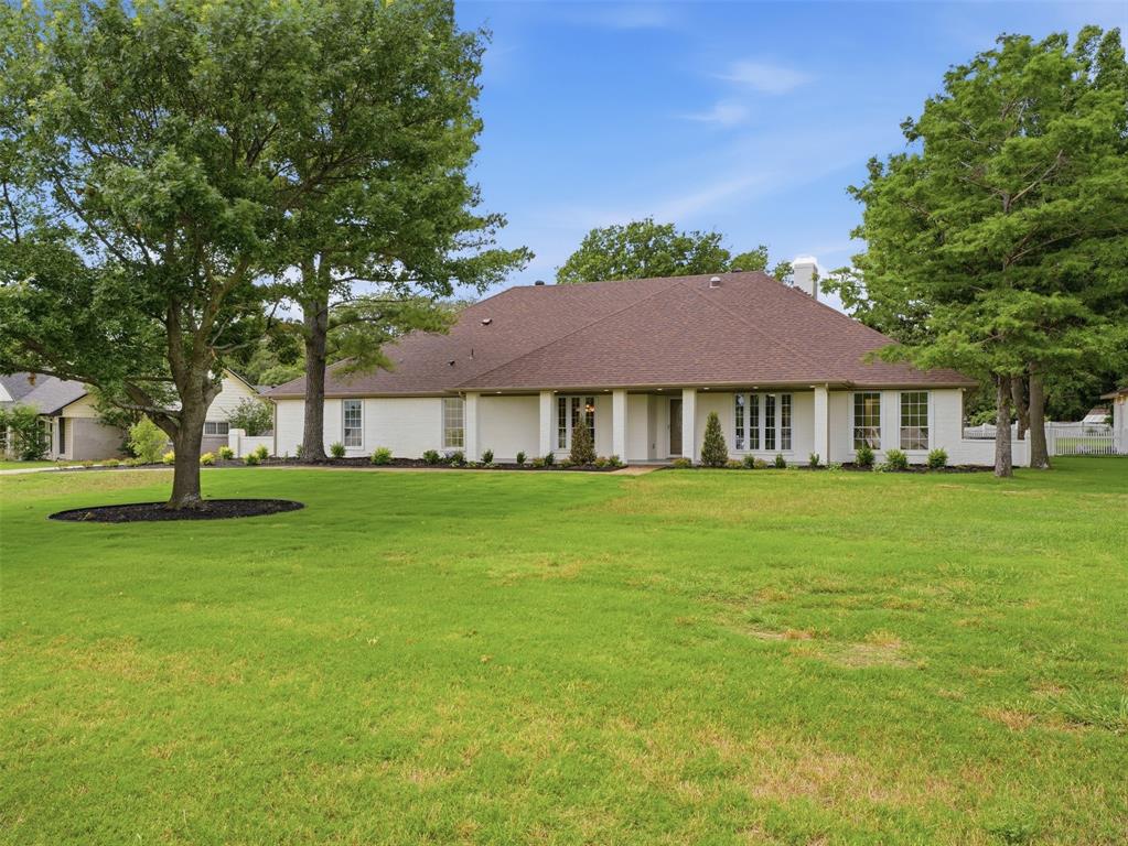Price improvement and this home is a dream! Sitting on a 1.14-acre corner lot in Double Oak, extensively renovated with thoughtful updates throughout. 4 bed, 3 bath, 3,130 sqft, and nothing left to do but move in. The main living space sets the tone. Vaulted ceilings stretch overhead, a moody black brick fireplace anchors the room with custom built-ins, and a 12-foot iron bifold door opens the entire back wall to the pool beyond. Inside and out blur together, which is a major vibe. The kitchen keeps that energy going with custom cabinetry, quartz counters and matching backsplash, stainless appliances, and a pot filler at the range. A bright dining area with a designer chandelier sits just off the kitchen, and a separate wet bar means the host actually gets to enjoy the party. The private study steals the show with rich green paneled walls and custom built-ins that make working from home feel intentional. A custom mudroom with bench seating and marble-look tile keeps the everyday hustle organized. The primary suite is amazing: freestanding soaking tub, oversized walk-in shower with glass enclosure, double quartz vanity, and a tiled accent wall that pulls the spa look together. Outside is where this place really shows off. A sparkling pool, covered patio made for slow Sunday mornings, mature trees, fresh landscaping, and a fully enclosed backyard that feels worlds away. A separate ADU is set up as a home gym, ready to flex as a guest suite, studio, or office. The bones got just as much love as the finishes: new electrical panel, new HVAC ducts and thermostats, two new water heaters, seamless gutters, and foundation work backed by a lifetime transferable warranty. Double Oak is one of Denton County's best-kept secrets, where 1-acre minimum zoning helps preserve the quiet, spacious feel. Spend weekends on Lake Grapevine, grab dinner down the road, browse The Shops at Highland Village, tee off at Bridlewood, and enjoy easy access to DFW Airport, Dallas, and Fort Worth.